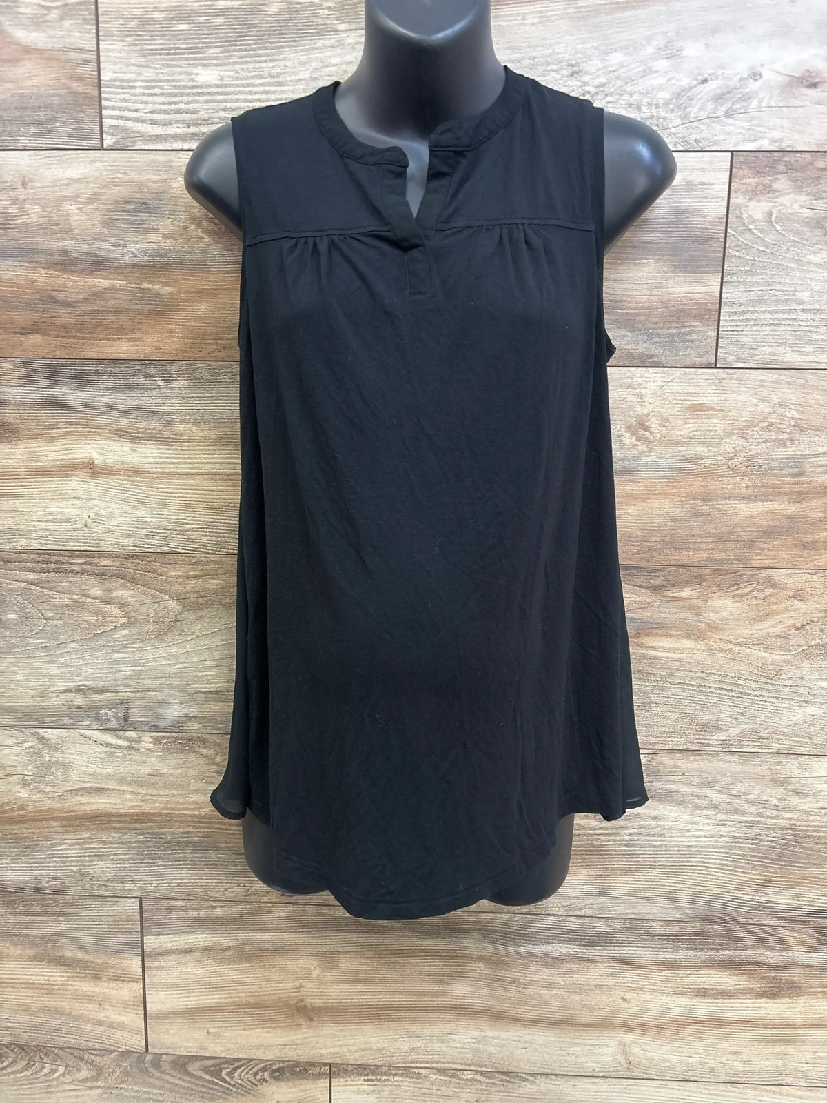 Front view of Liz Lange black maternity tank top showcasing sleeveless cut and gathered yoke on mannequin