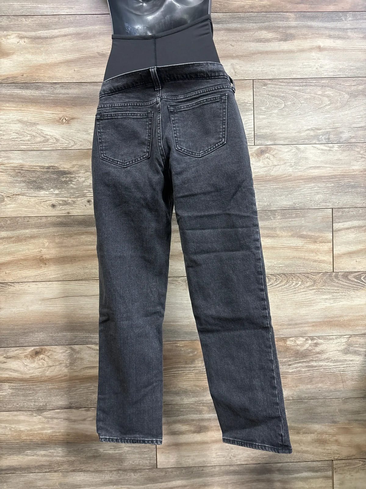 Back view of Abercrombie & Fitch ‘90s straight maternity jeans showcasing full-panel stretch waistband on wood floor background