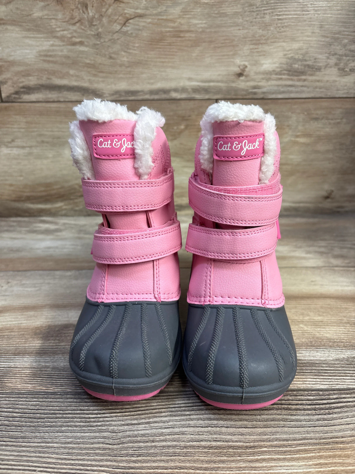 Front view of Cat & Jack toddler winter boots, pink with gray rubber toe, two Velcro straps and white faux-fur lining