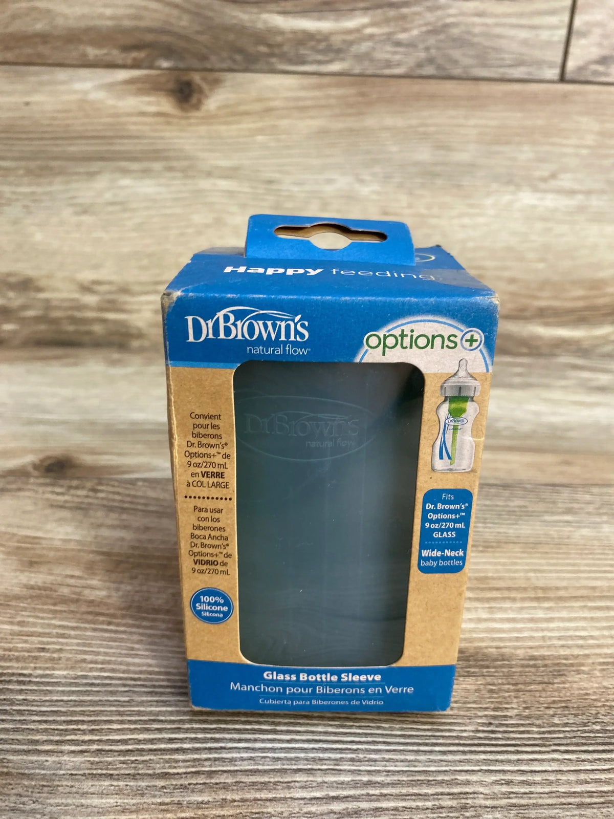 Dr. Brown's Options+ glass bottle sleeve in retail packaging on wooden surface