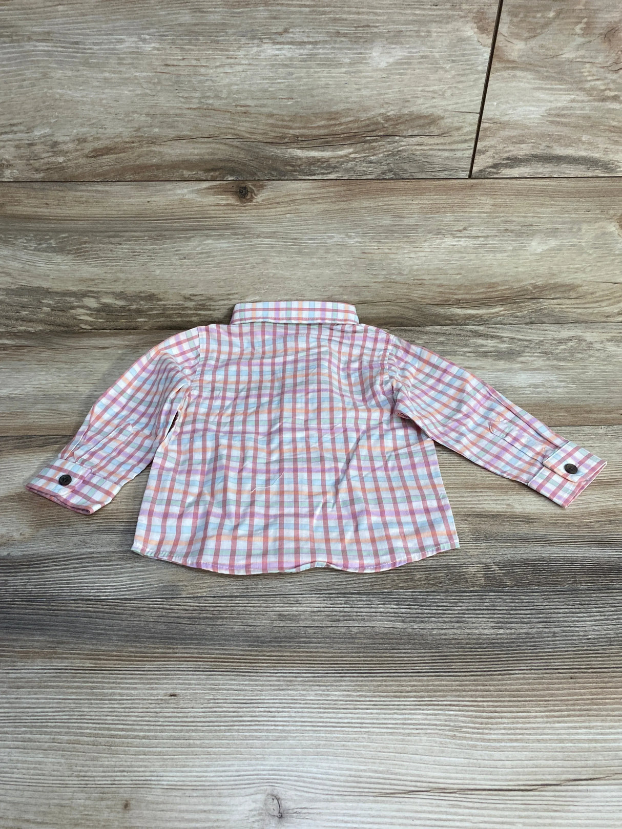 Back of Cat and Jack pink and white plaid baby button-up shirt size 12M showing collar and cuffs on wood background