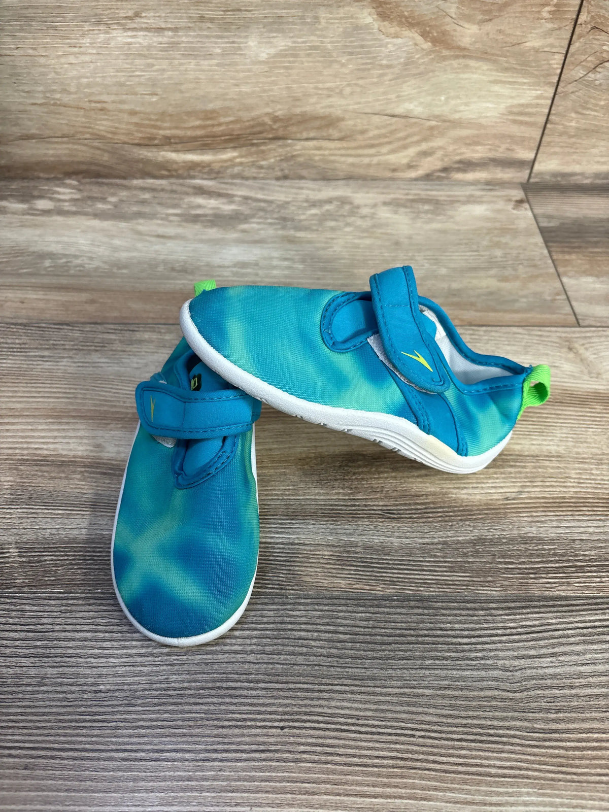 Top and side view of Speedo Shore Explorer water shoes showcasing mesh uppers and easy closures on wood-look flooring