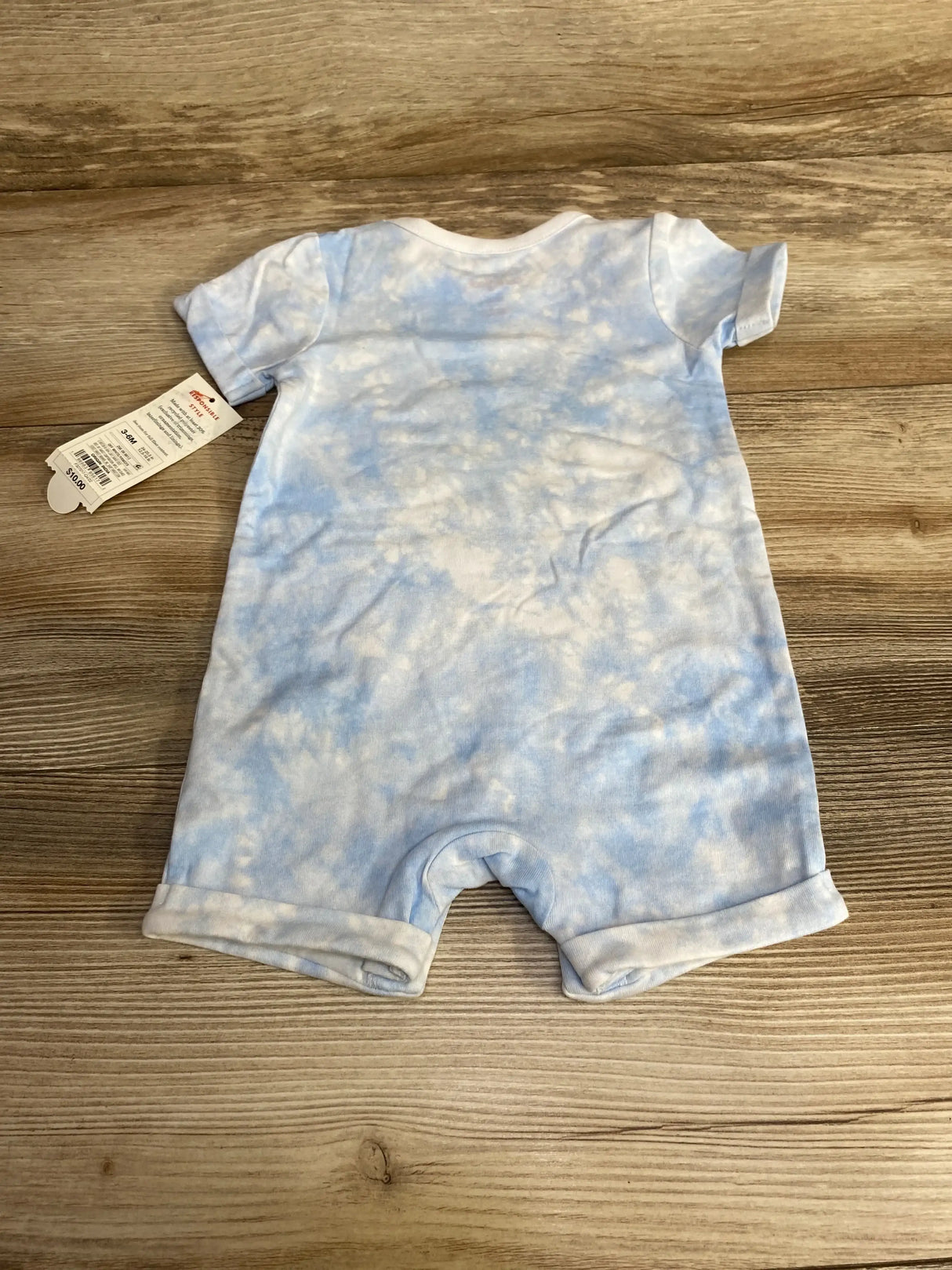 Back flat lay of Cat & Jack Lil Snuggle Bunny romper showing blue cloud tie-dye, short sleeves and rolled cuffs on wood background