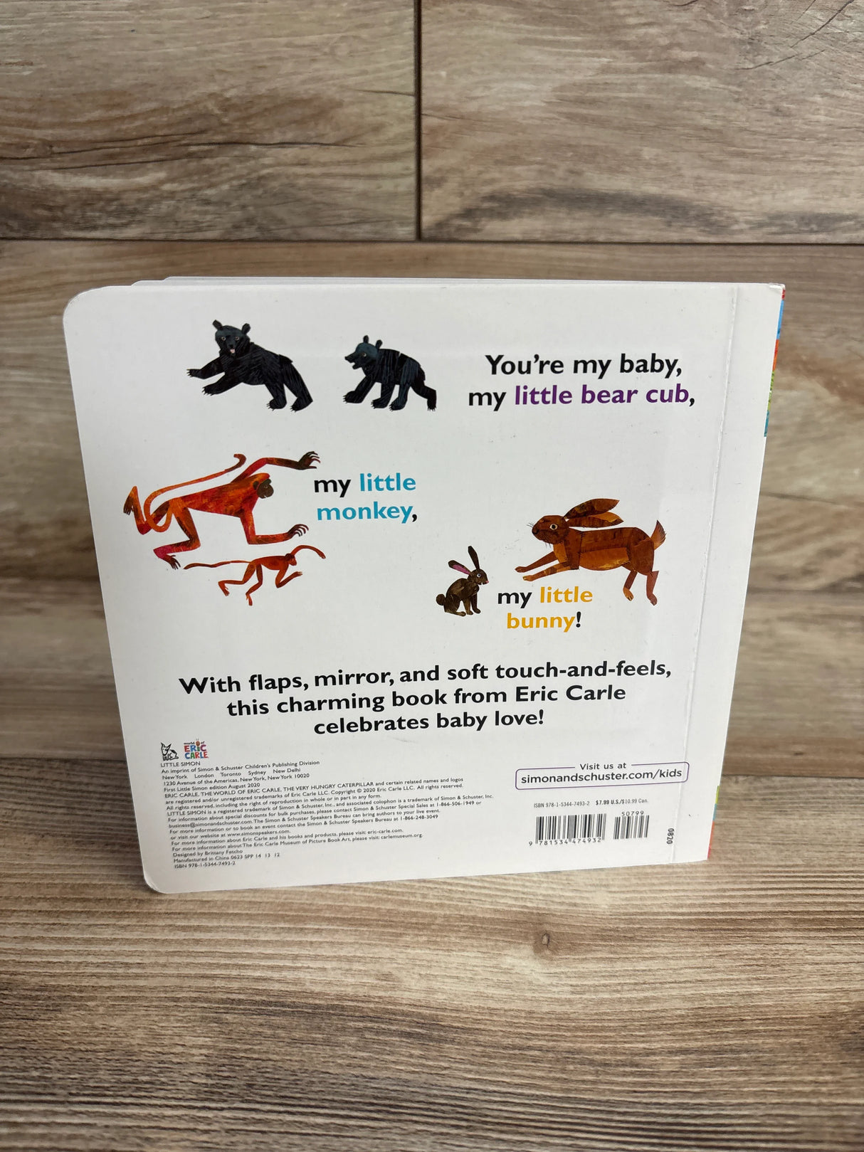 Back cover of Eric Carle baby book featuring illustrations of bear cubs, monkeys, and bunnies with text about baby love