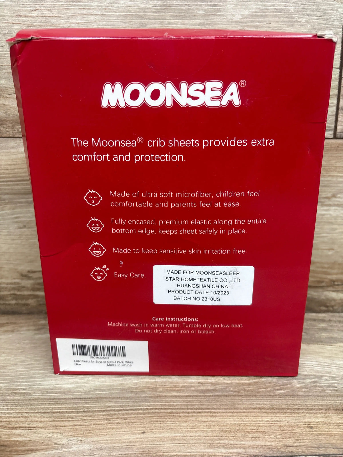 Back view of Moonsea 4-pack crib sheets package showcasing microfiber and full elastic edge on a wood surface