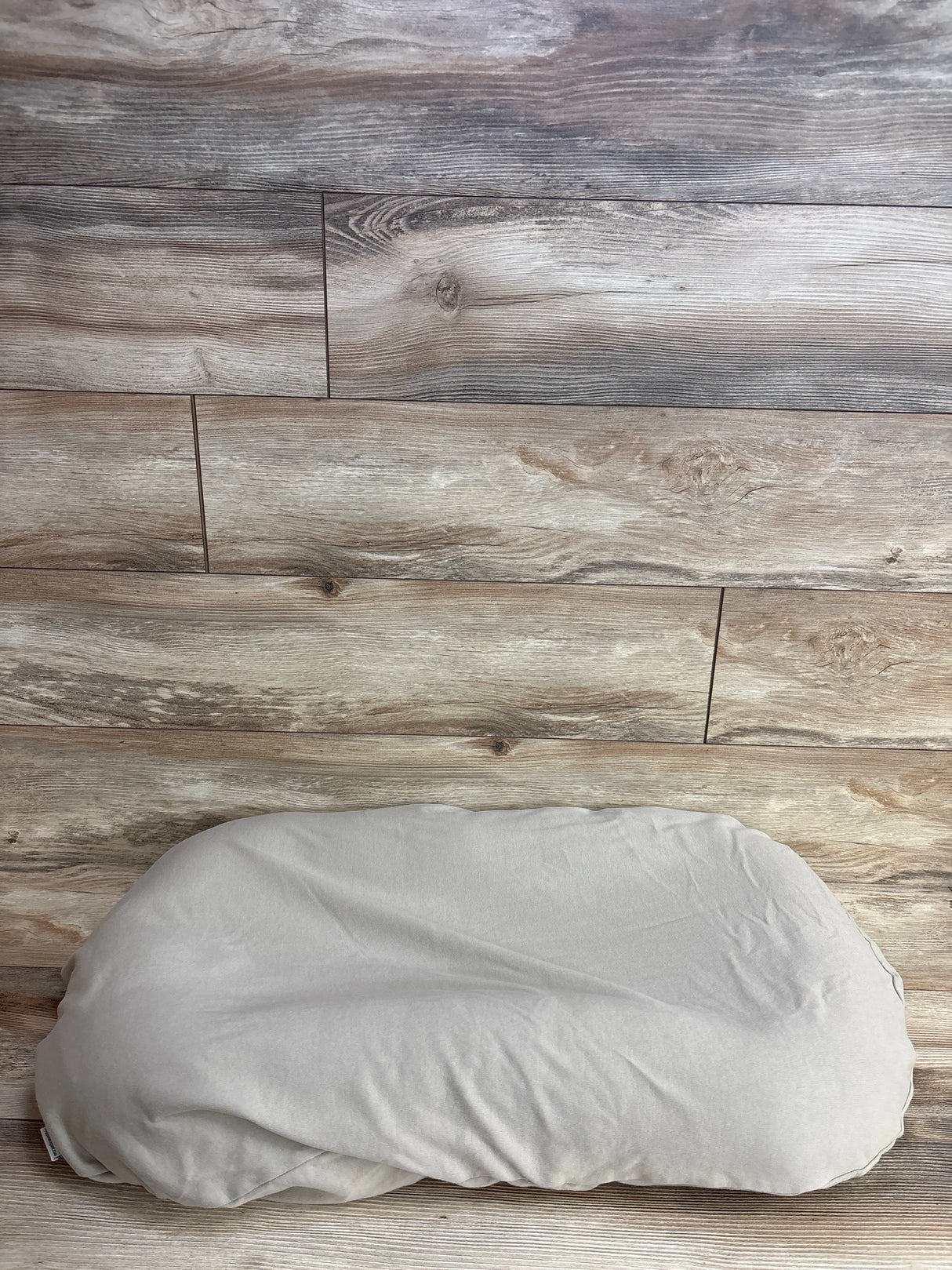 Beige pillow on wood floor with rustic plank background