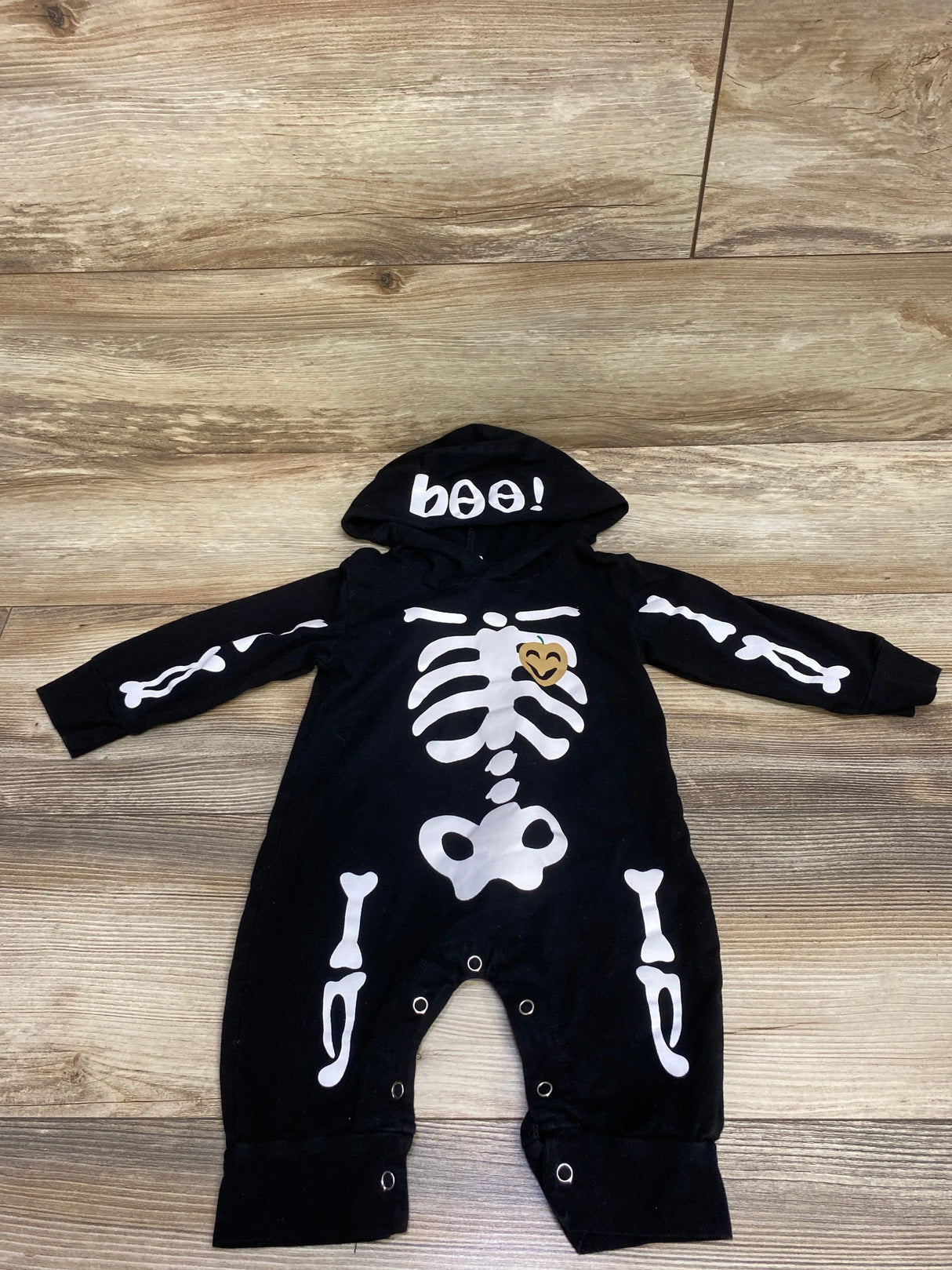 Black skeleton Halloween baby onesie with 'boo!' hood and bone print, perfect for festive baby costumes.