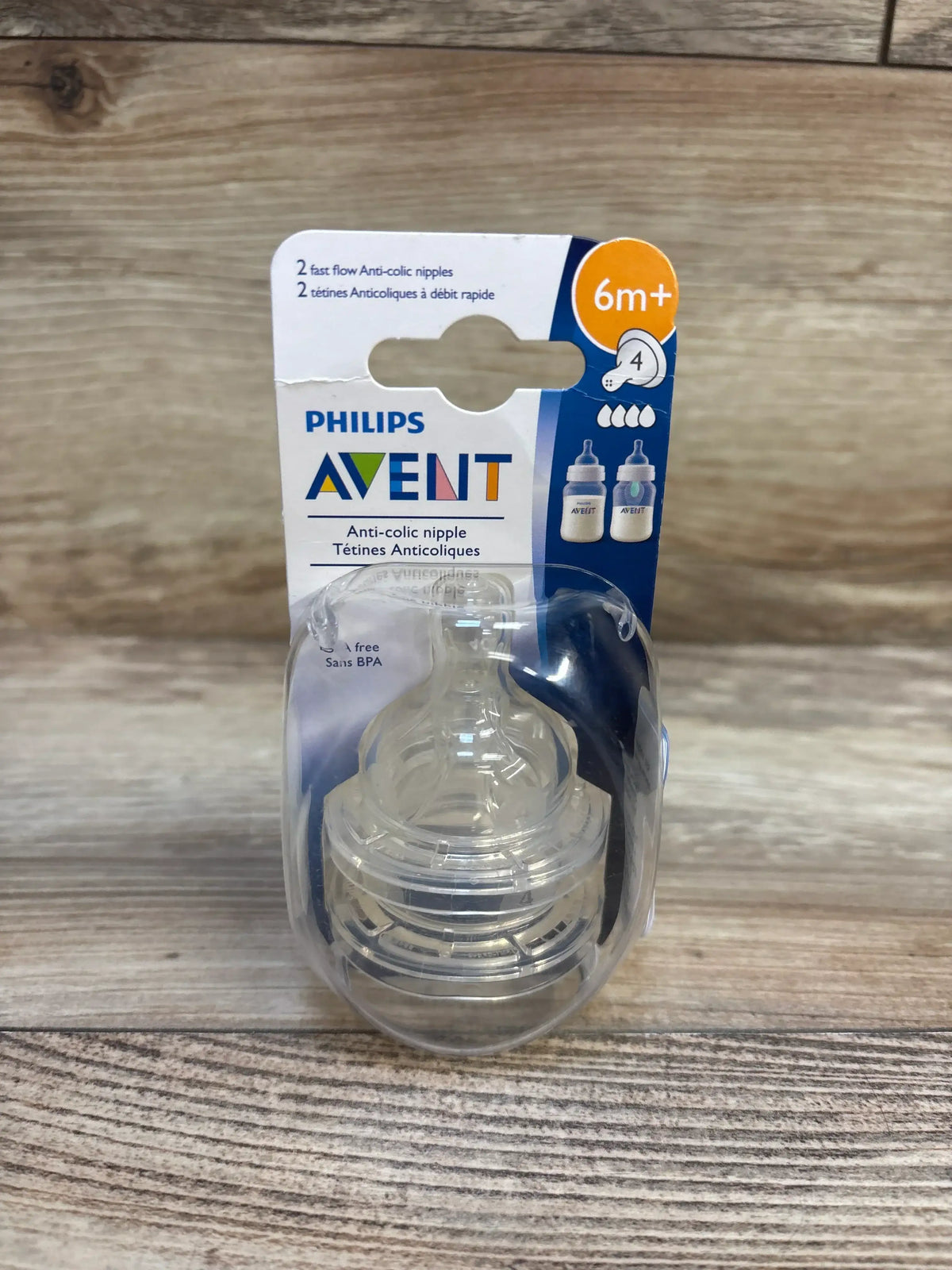 Front view of Philips Avent 2-pack anti-colic fast-flow nipples showcasing level 4 6 months and up marking in sealed blister on wood