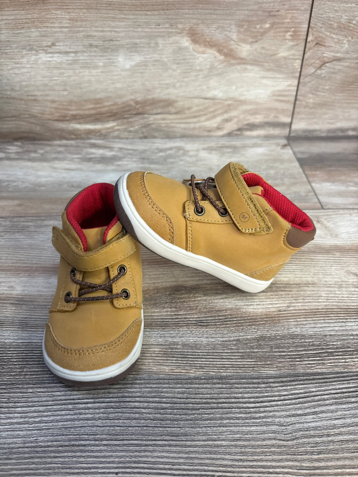 Angled view of Stride Rite 360 Indiana Honey Yellow sneaker boot sz 6c showcasing hook and loop closures on a wood floor