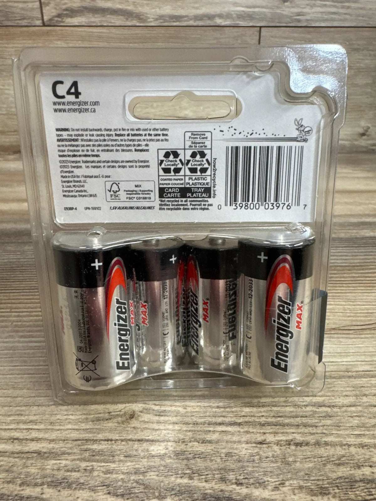 Back view of NEW Energizer Max C Batteries 4pk Alkaline showcasing four C cell batteries in sealed blister packaging on wood plank floor