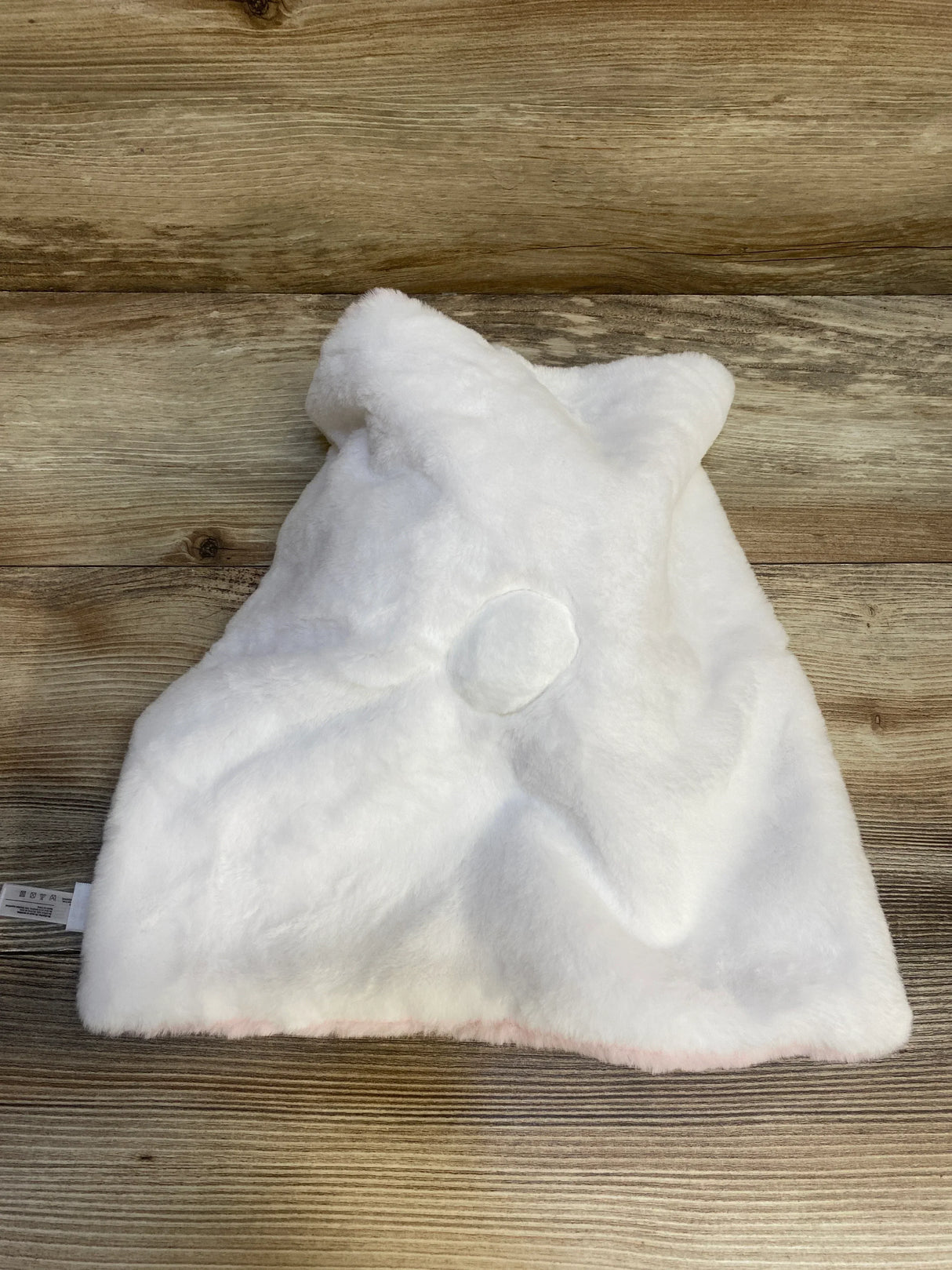 Back view of NEW DreamGro Buddy Blankie Pink Unicorn Security Blanket showcasing white plush body unicorn horn nub and pink trim on wood plank floor