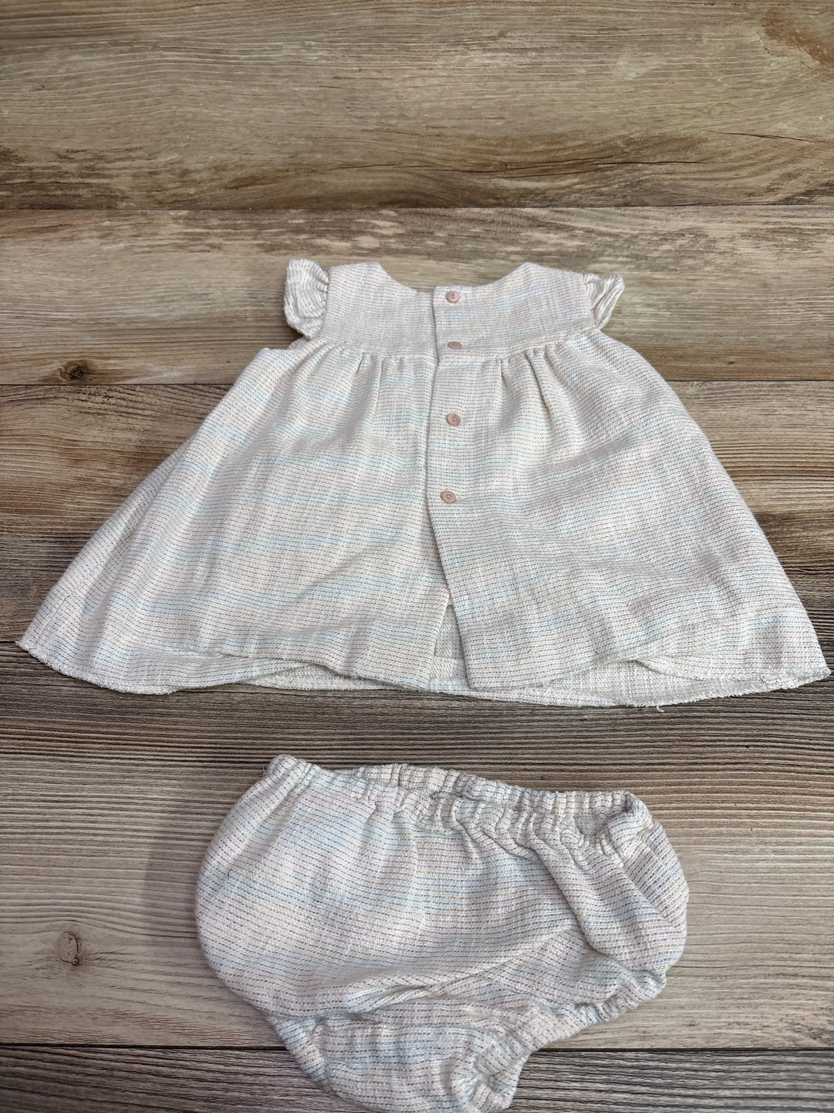 Zara Mini 2pc metallic ivory dress with ruffles and matching bloomers on a wood background