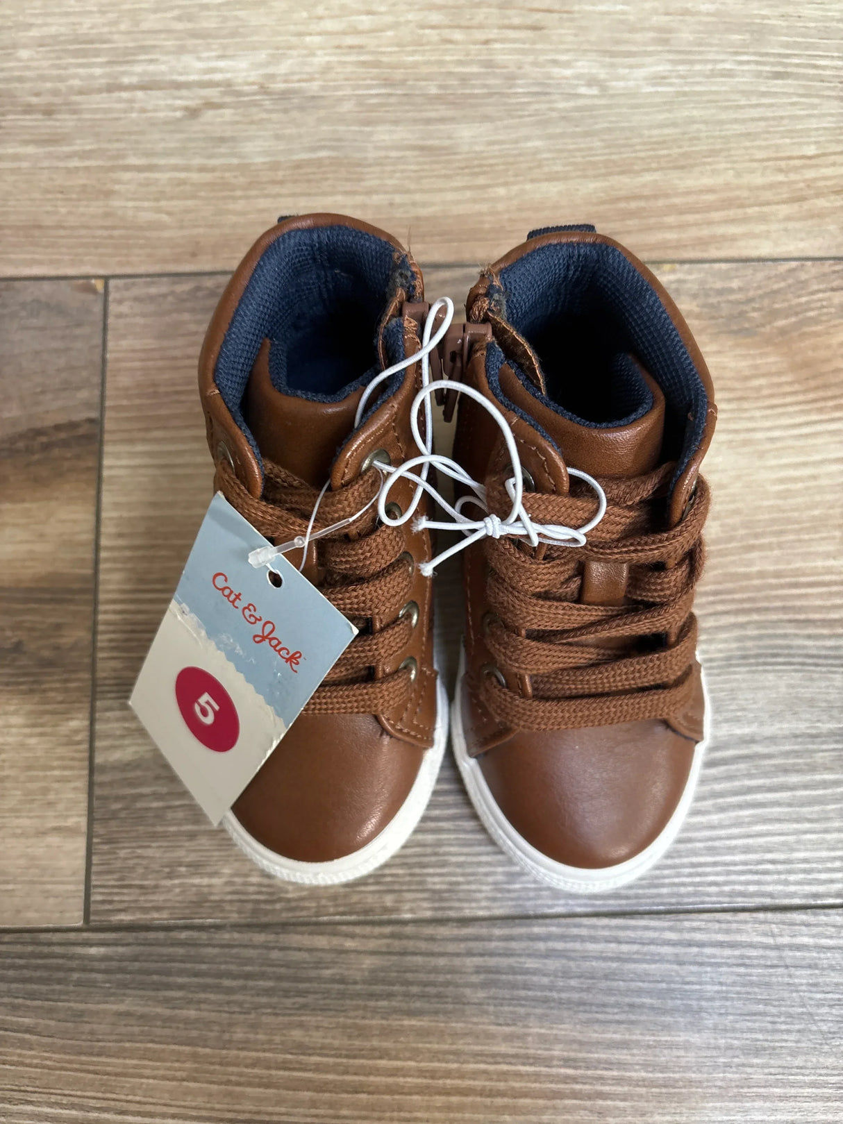 Brown Cat & Jack toddler sneakers with laces, size 5, on wood floor