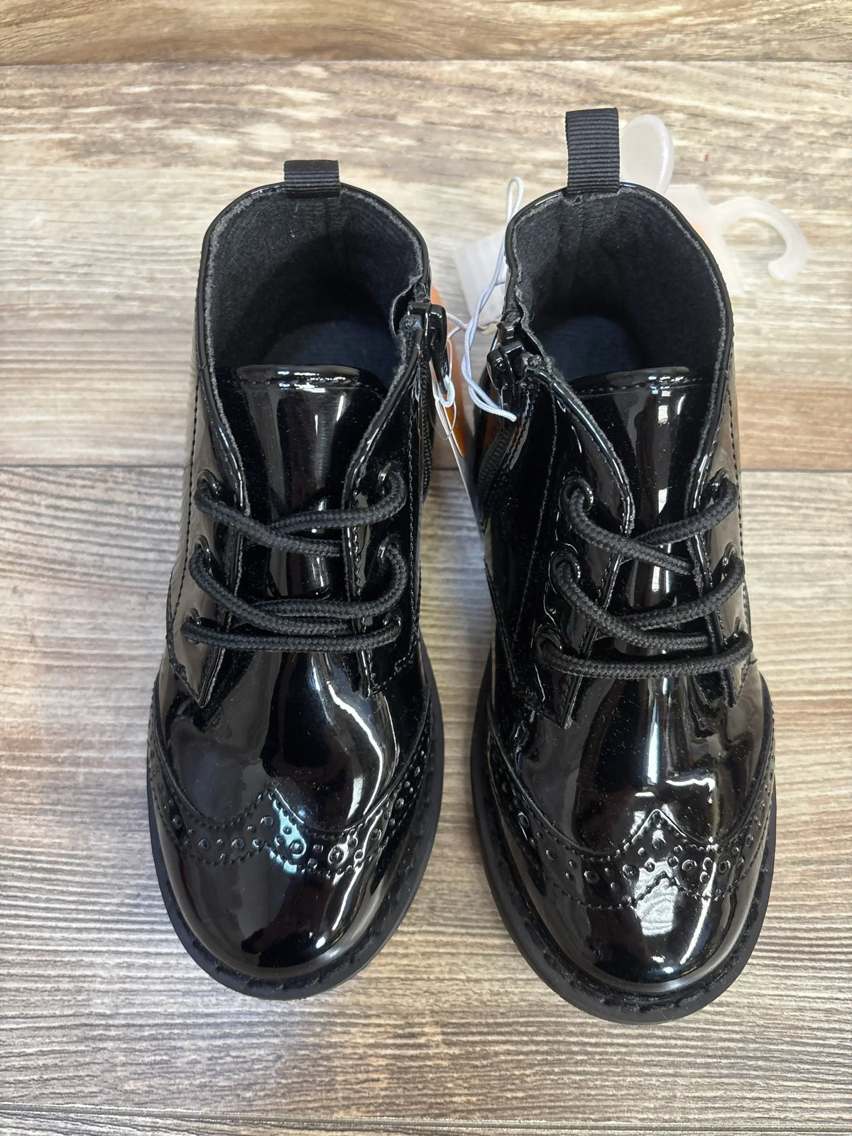 Shiny black patent leather toddler dress shoes with laces and side zippers, perfect for kids' formal wear.