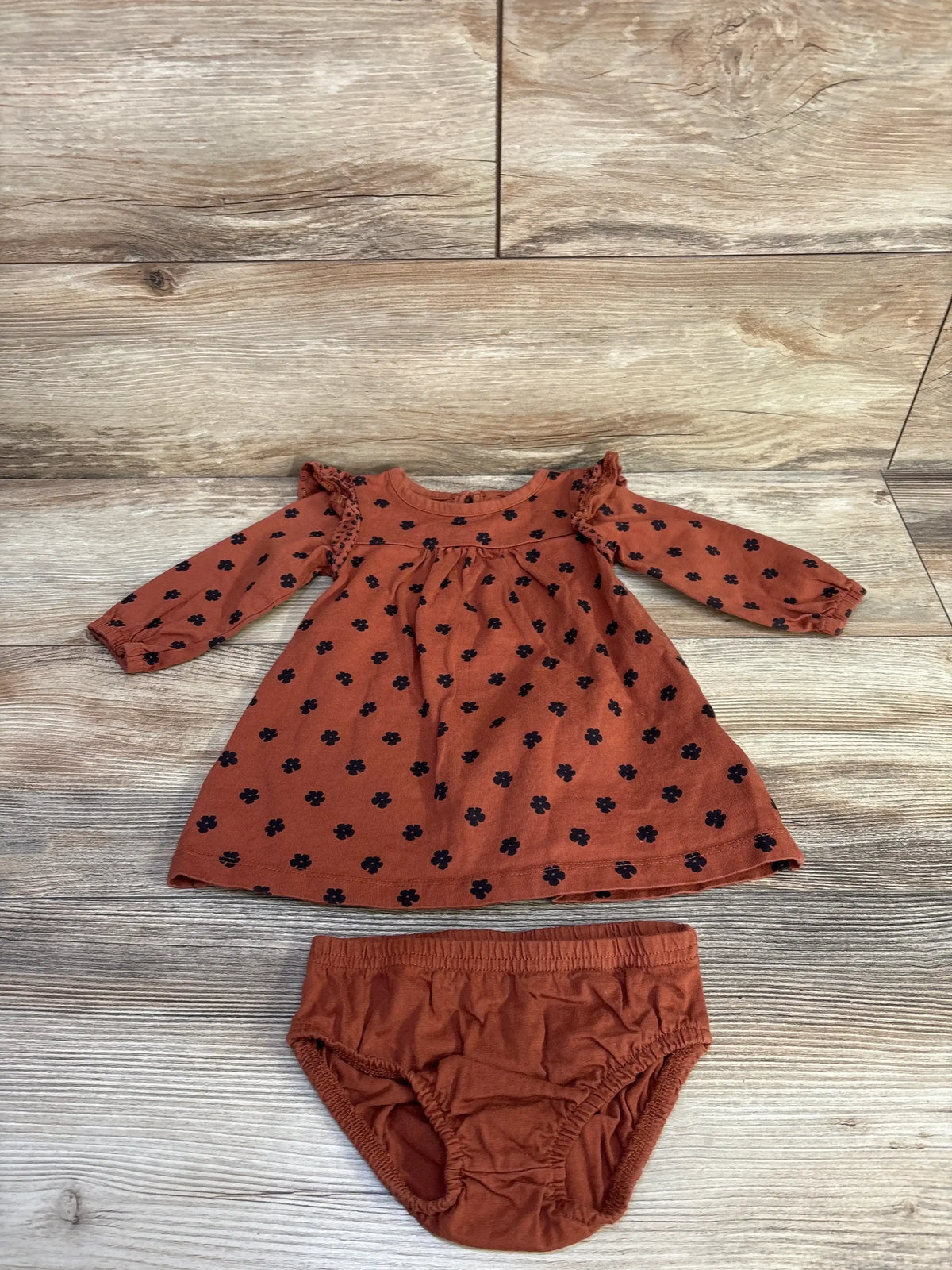 Front view of 2-piece baby dress and matching bloomers (brown, 9 months) showcasing ruffled sleeves and elastic waist on white background