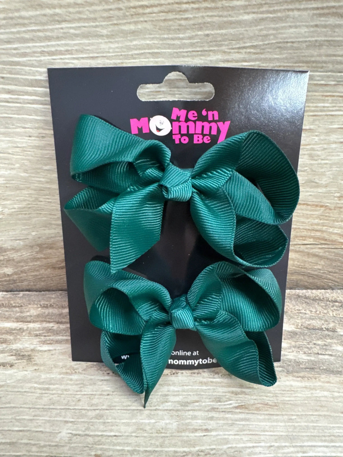 Front view of medium green hair bows (2-pack) showcasing knotted ribbon and alligator clips on white background