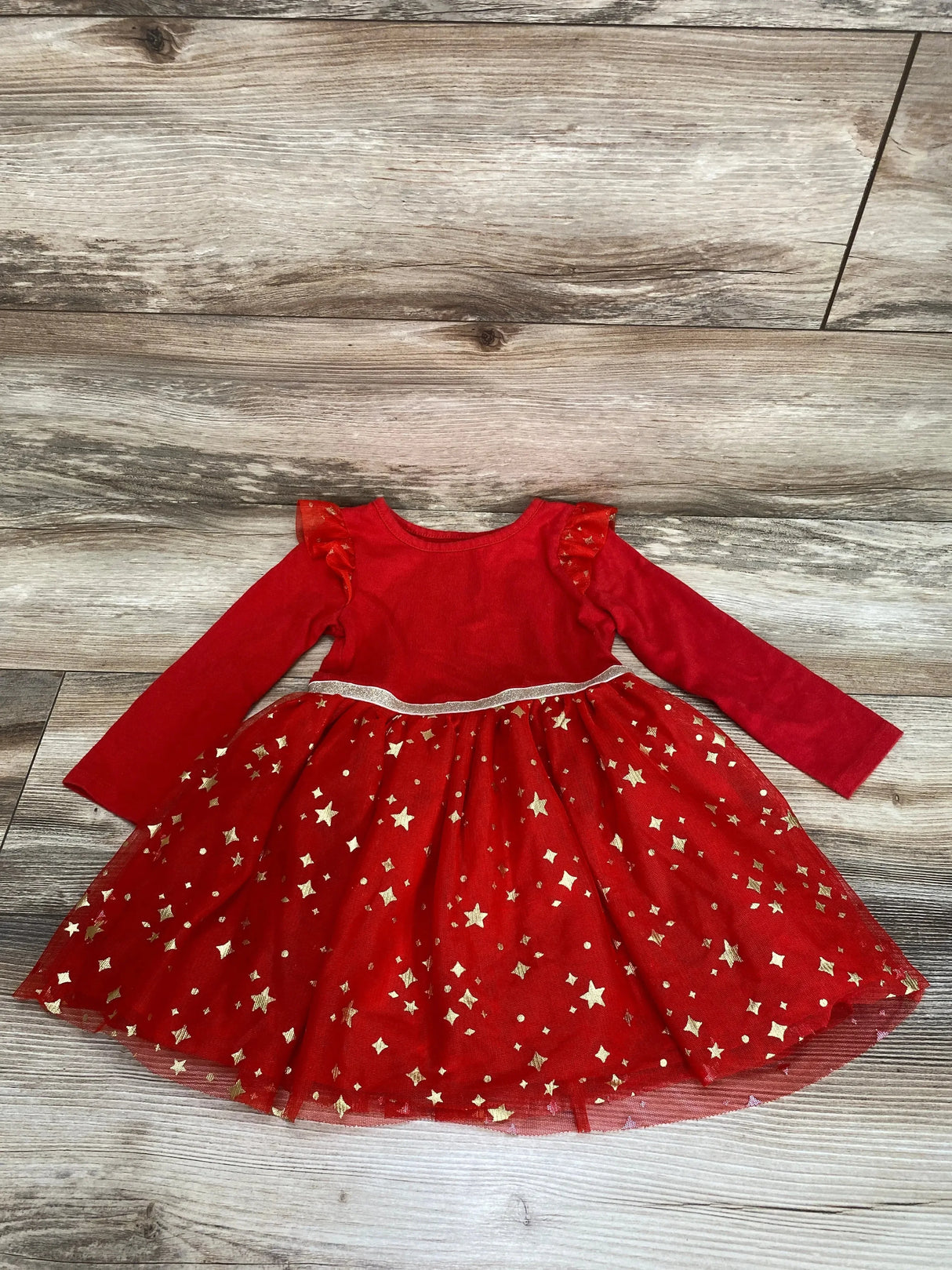 Front flat-lay of red Cat and Jack toddler tulle dress size 2T showcasing ruffle shoulders, silver waist trim and gold star tulle skirt on wood floor