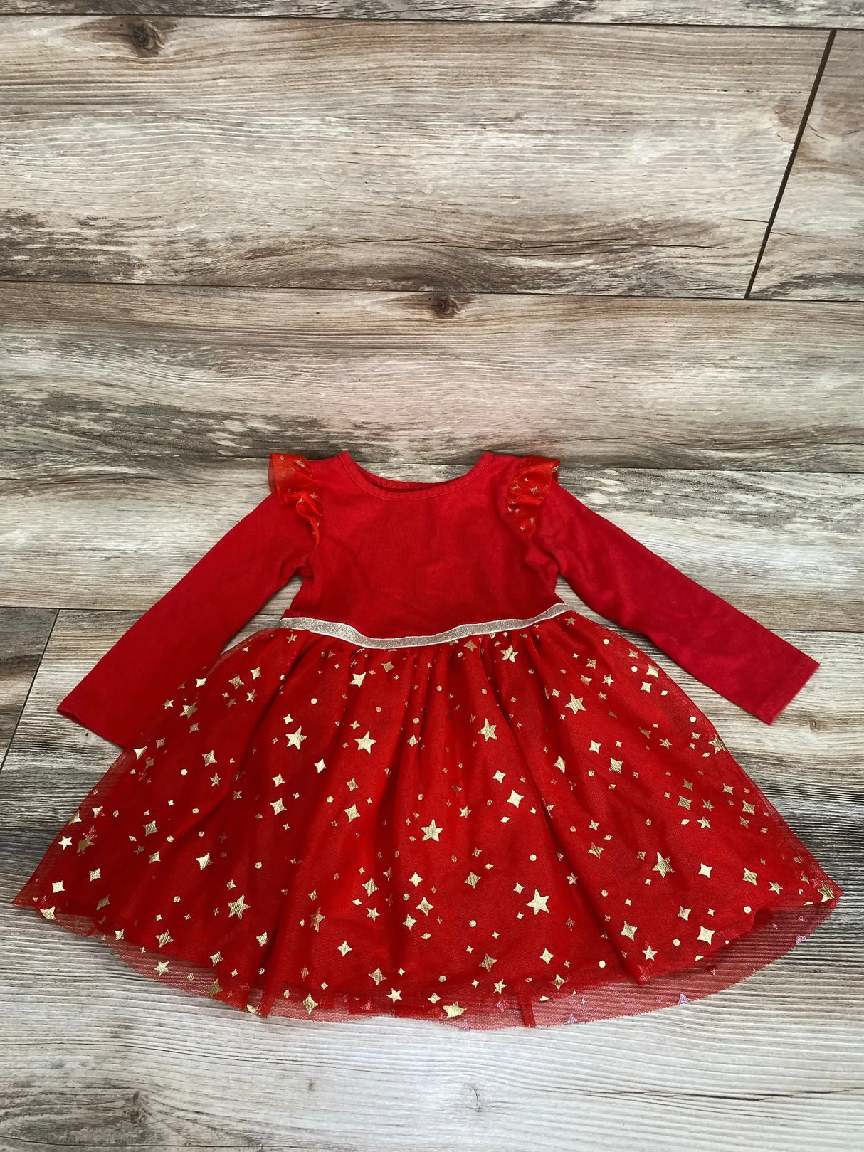 Front flat-lay of red Cat and Jack toddler tulle dress size 2T showcasing ruffle shoulders, silver waist trim and gold star tulle skirt on wood floor