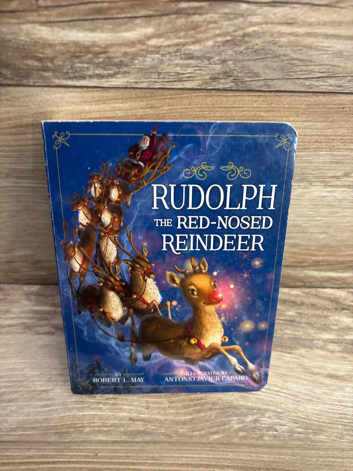 Rudolph the Red-Nosed Reindeer children's book with Santa sleigh, festive holiday story for kids