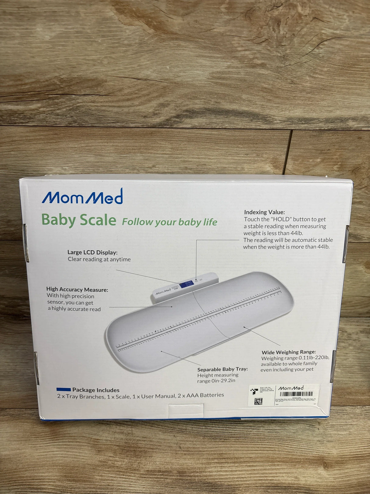 Front view of MomMed 24in Baby Scale box showcasing product image, large LCD display and separable height-measuring tray on a wood floor background