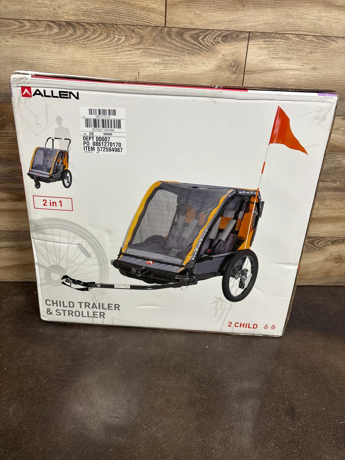 Front view of Allen child bike trailer and stroller with mesh cover, orange trim and safety flag on boxed packaging