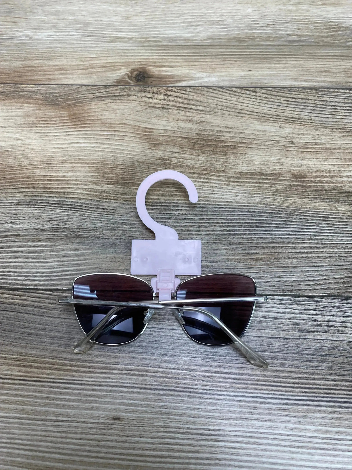 Front view of More Than Magic sunglasses showcasing tinted lenses and rounded black plastic frame on white background