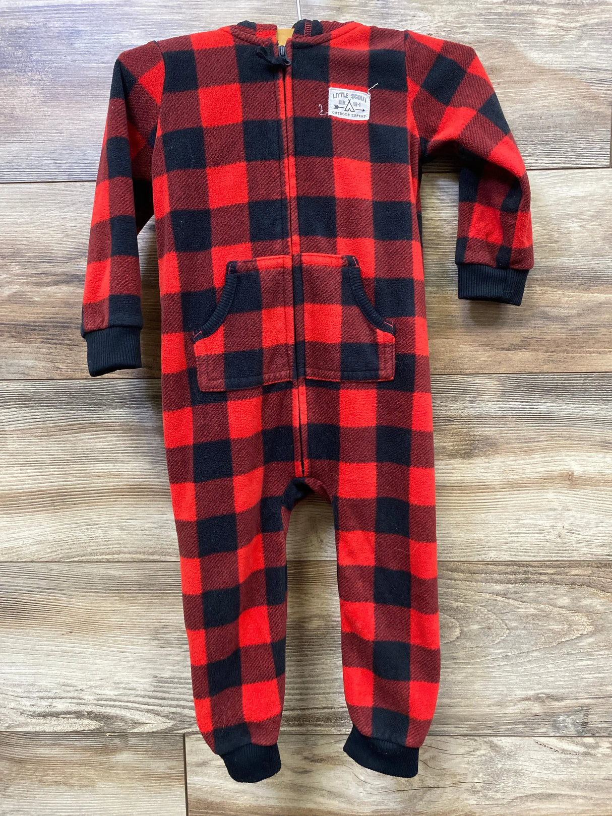 Red and black buffalo plaid fleece kids onesie with front zipper and pockets on wooden floor