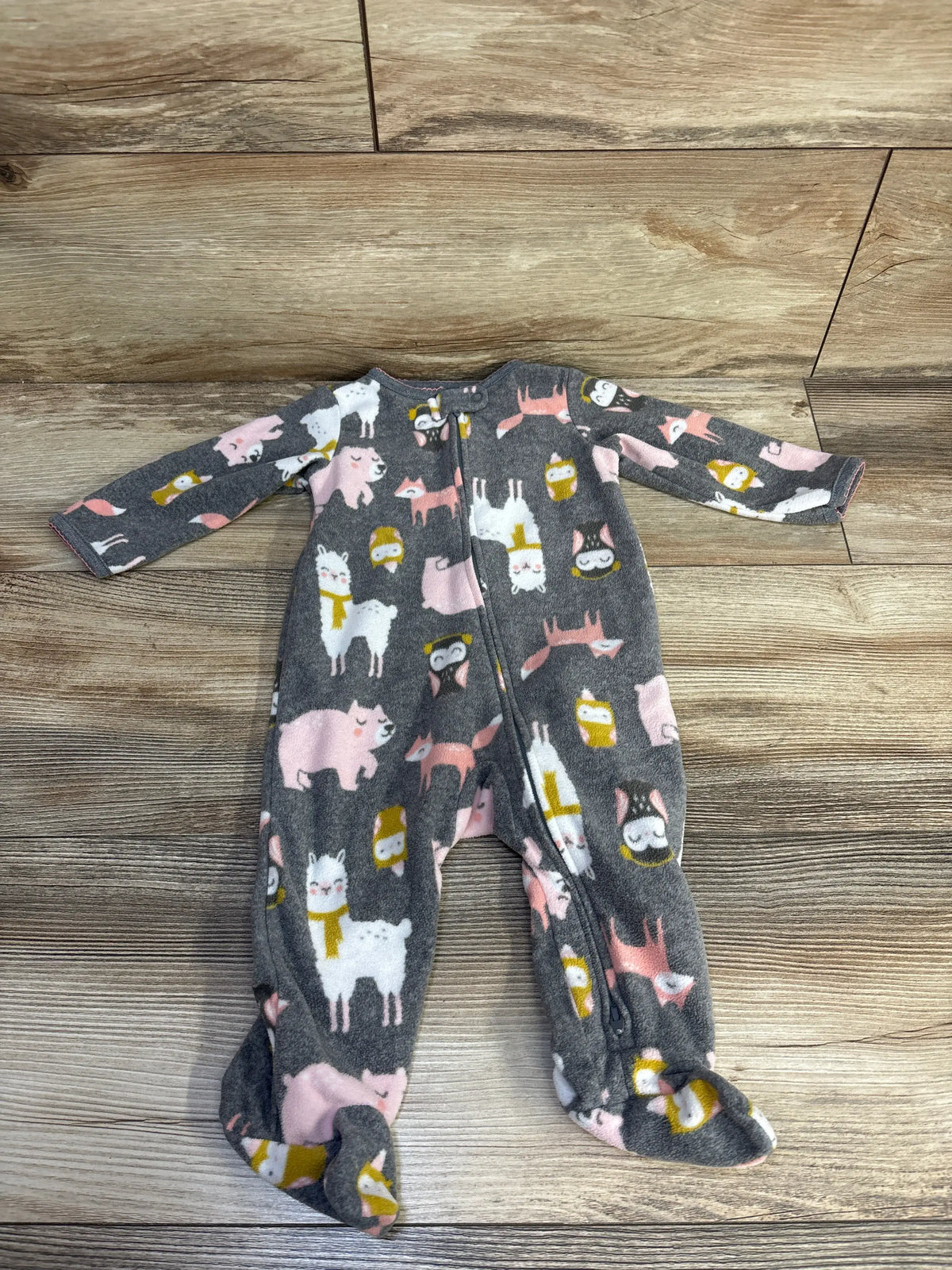Front view of a grey Simple Joys blanket sleeper showcasing long sleeves, a full length zipper, footed legs, and an animal print