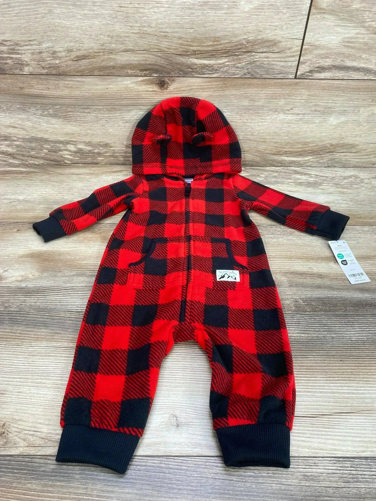 Front view of Carter's red buffalo-check baby jumpsuit (6M) with hood ears, front zipper, and cuffed ankles on wood floor