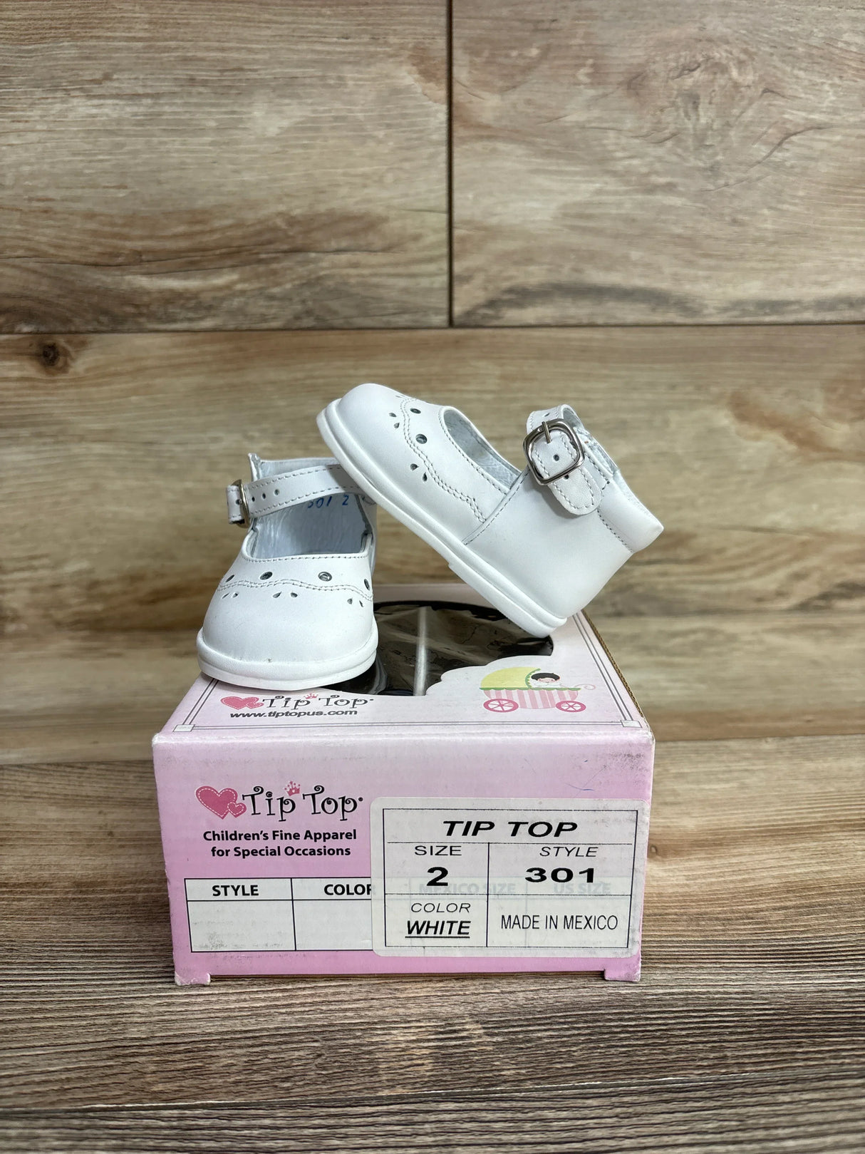 White toddler dress shoes with buckle, displayed on a Tip Top shoe box, size 2.