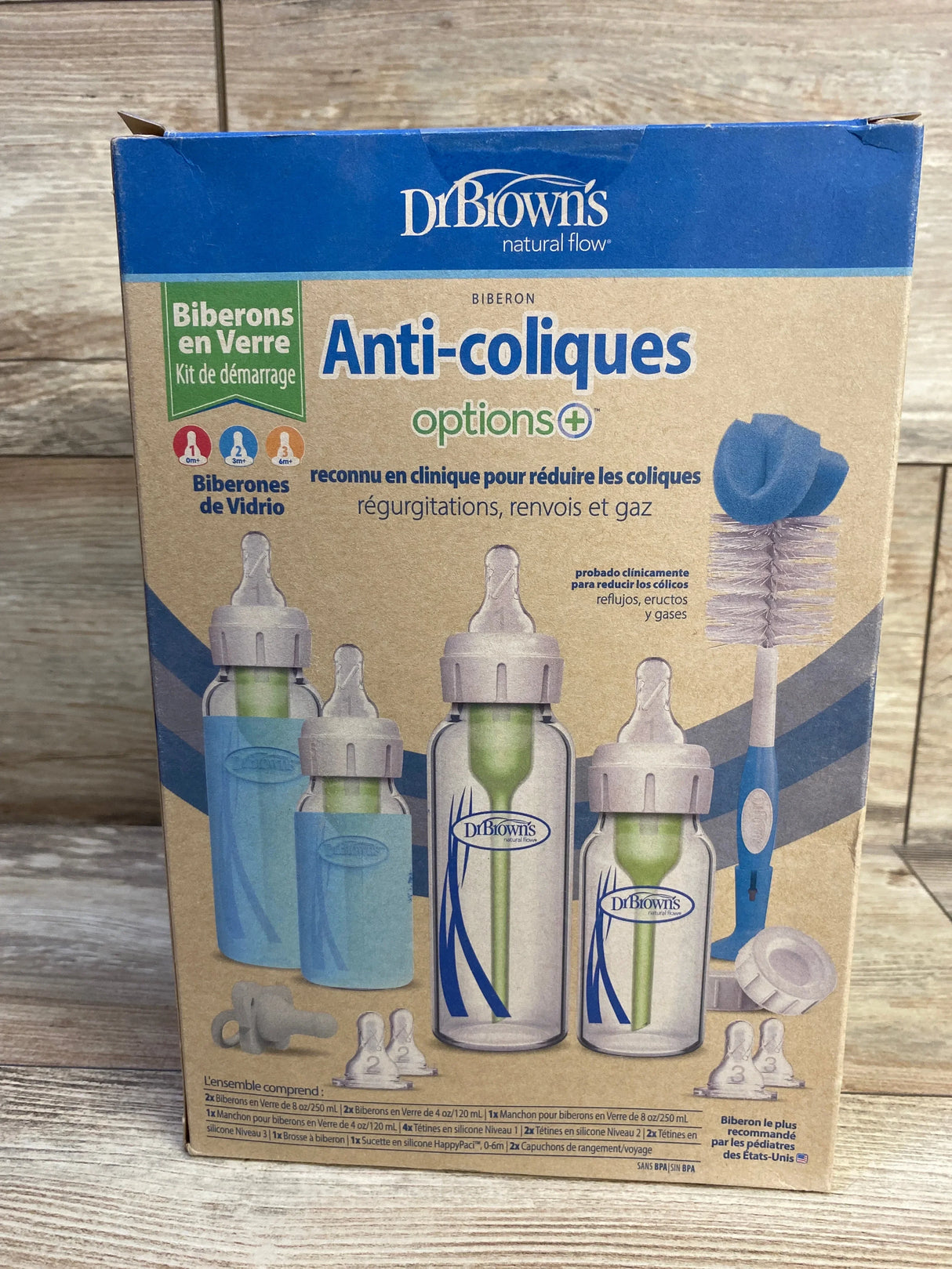 Front view of NEW Dr Brown's Anti-Colic Options+ Narrow Glass Baby Bottle Starter Set in original retail box on wood floor