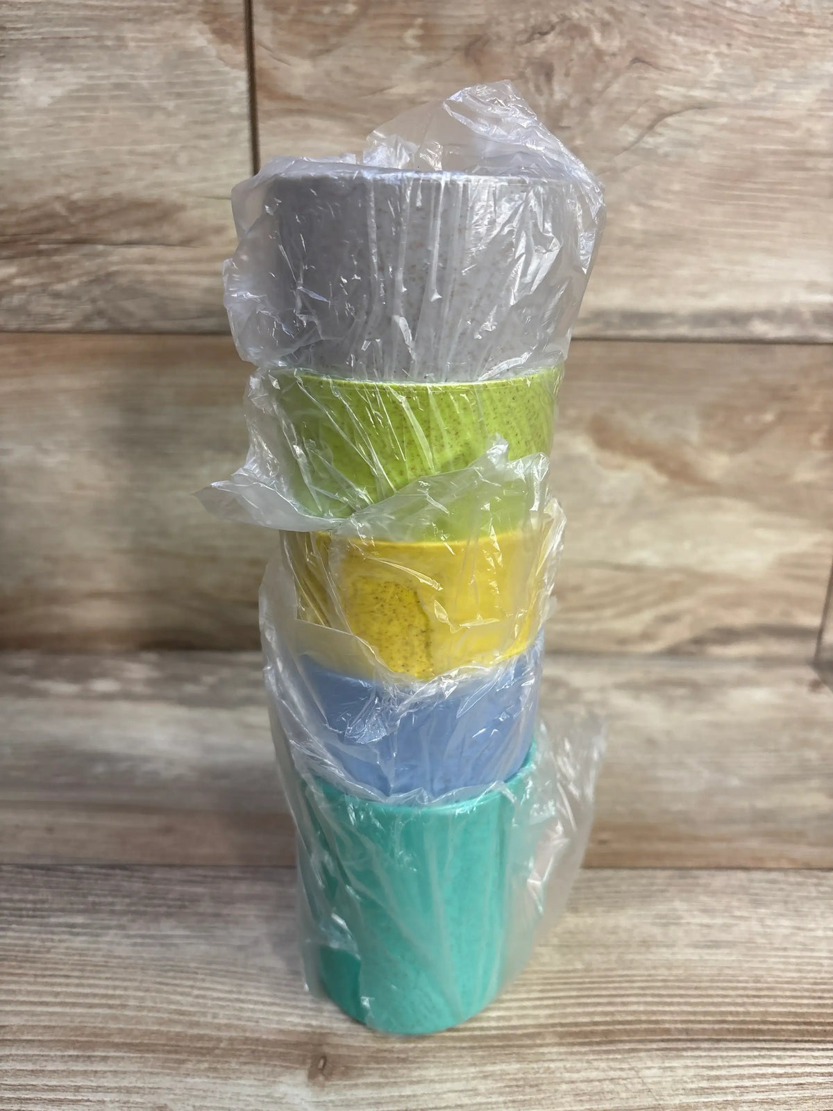 Stack of five colorful Youngever bamboo kids cups wrapped in clear plastic.