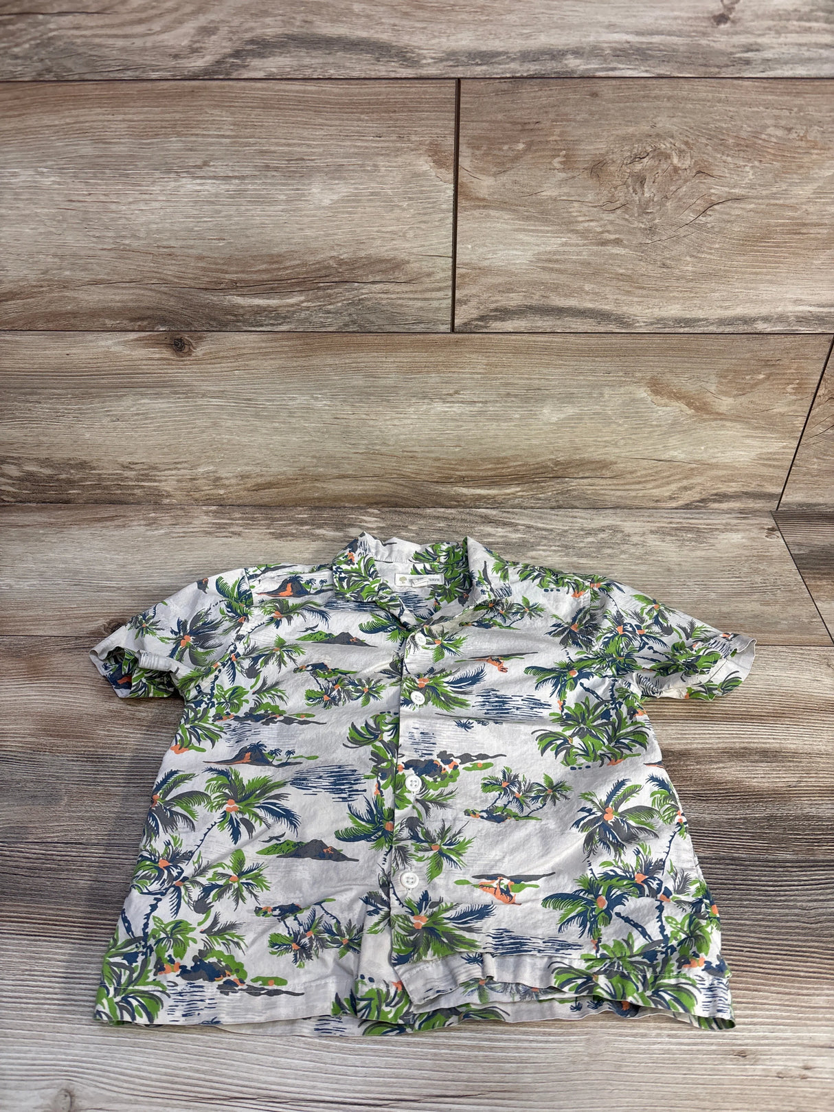 Front view of beige Tucker + Tate Hawaiian Dino button-up shirt with short sleeves, collar, button front, and allover print