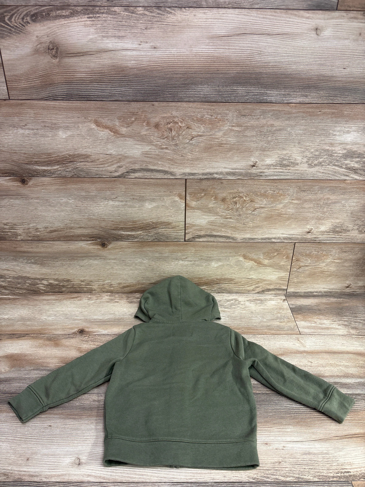 Back view of a green Old Navy zip-up hoodie for toddlers on a wood-plank background.