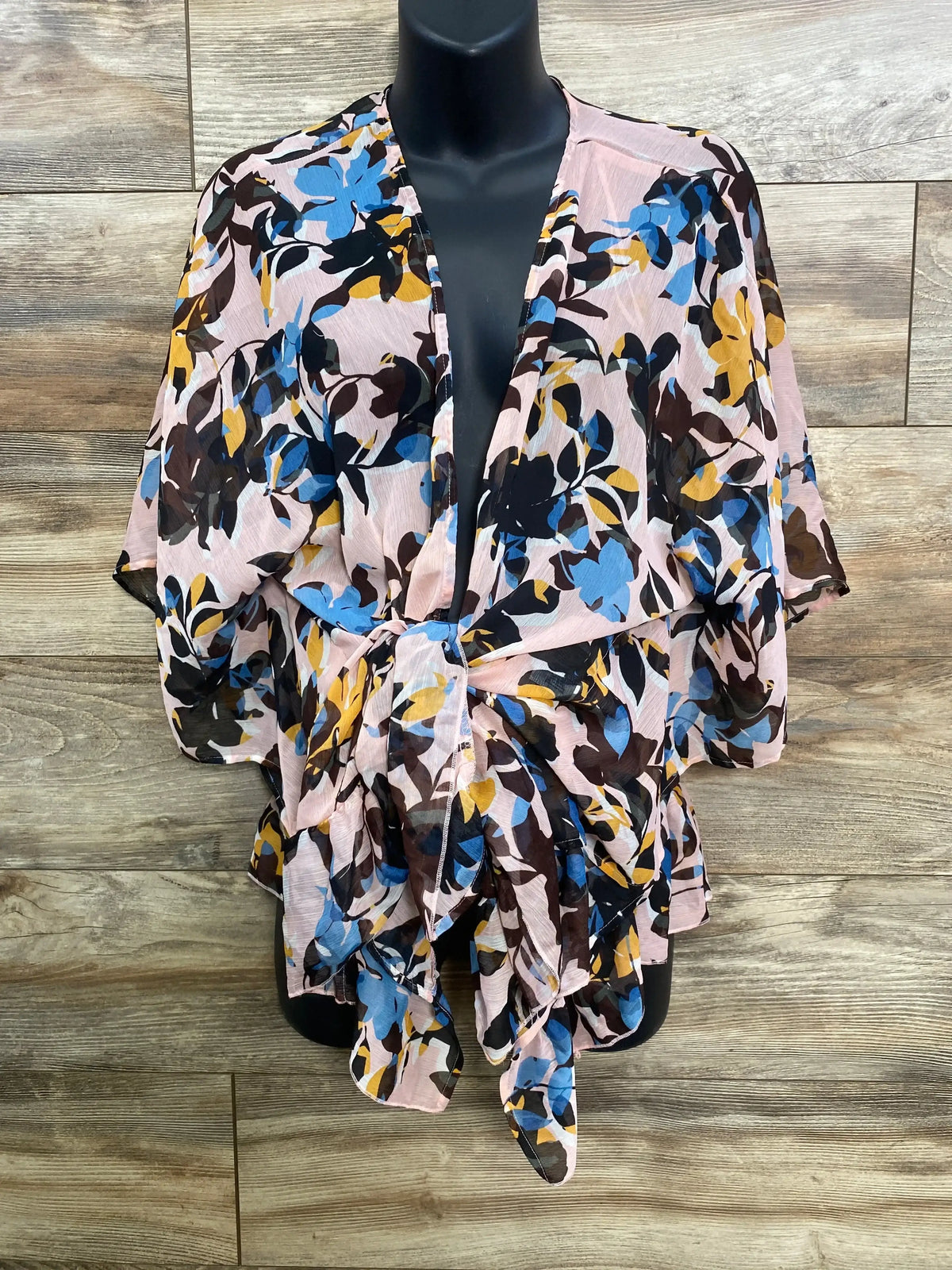 Front view of pink Motherhood Maternity open front kimono showcasing floral print and short sleeves on black mannequin