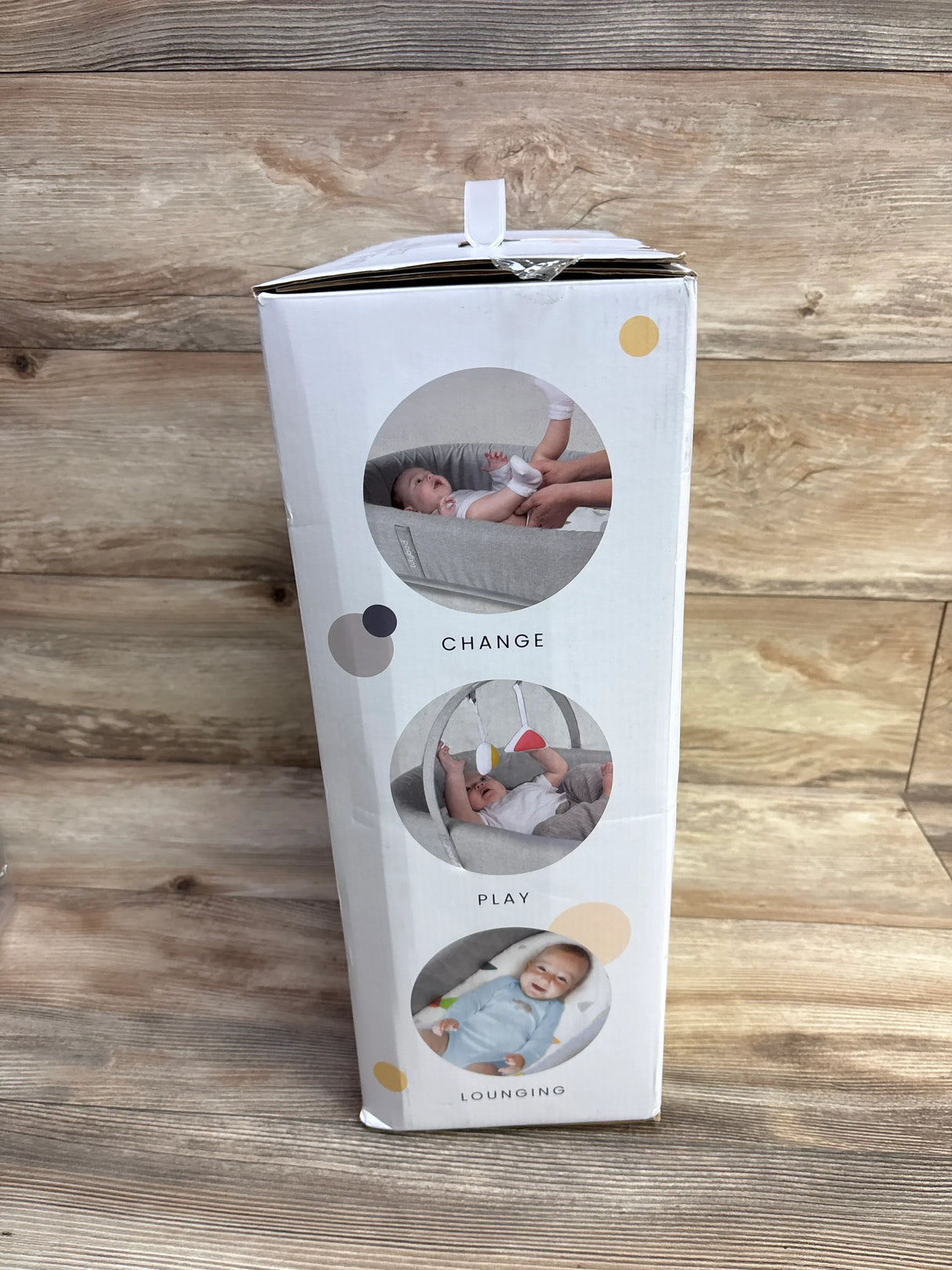 Baby activity lounger packaging showing baby changing, play, and lounging functions