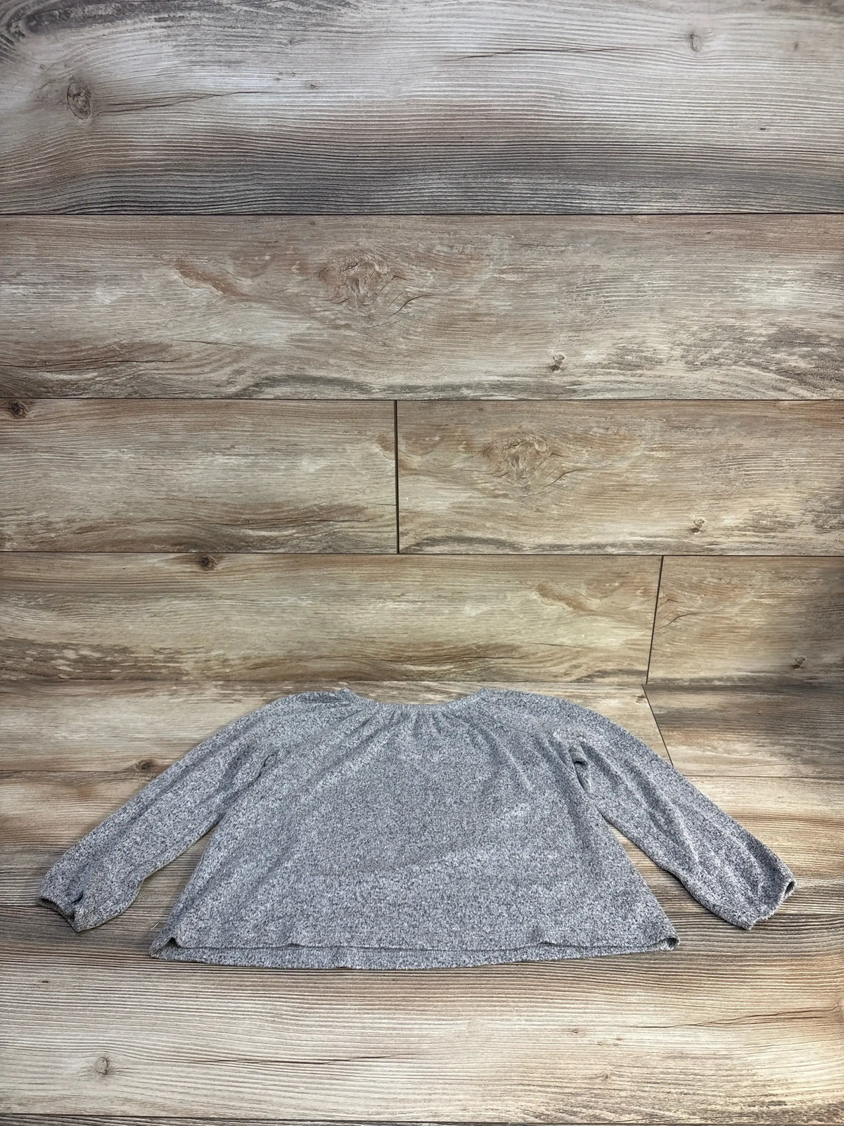 Flat lay of grey Old Navy long-sleeve toddler shirt size 5T showing gathered neckline and elastic cuffs on wood floor