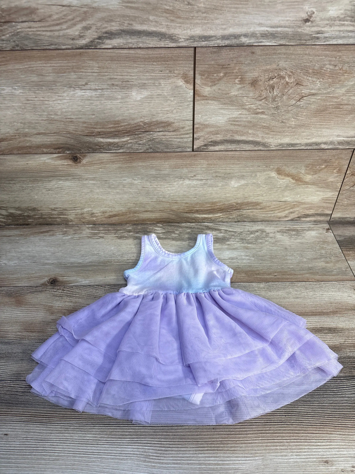 Front view of Old Navy lilac tulle bodysuit dress showcasing layered tulle overlay and sleeveless bodice on wood planks