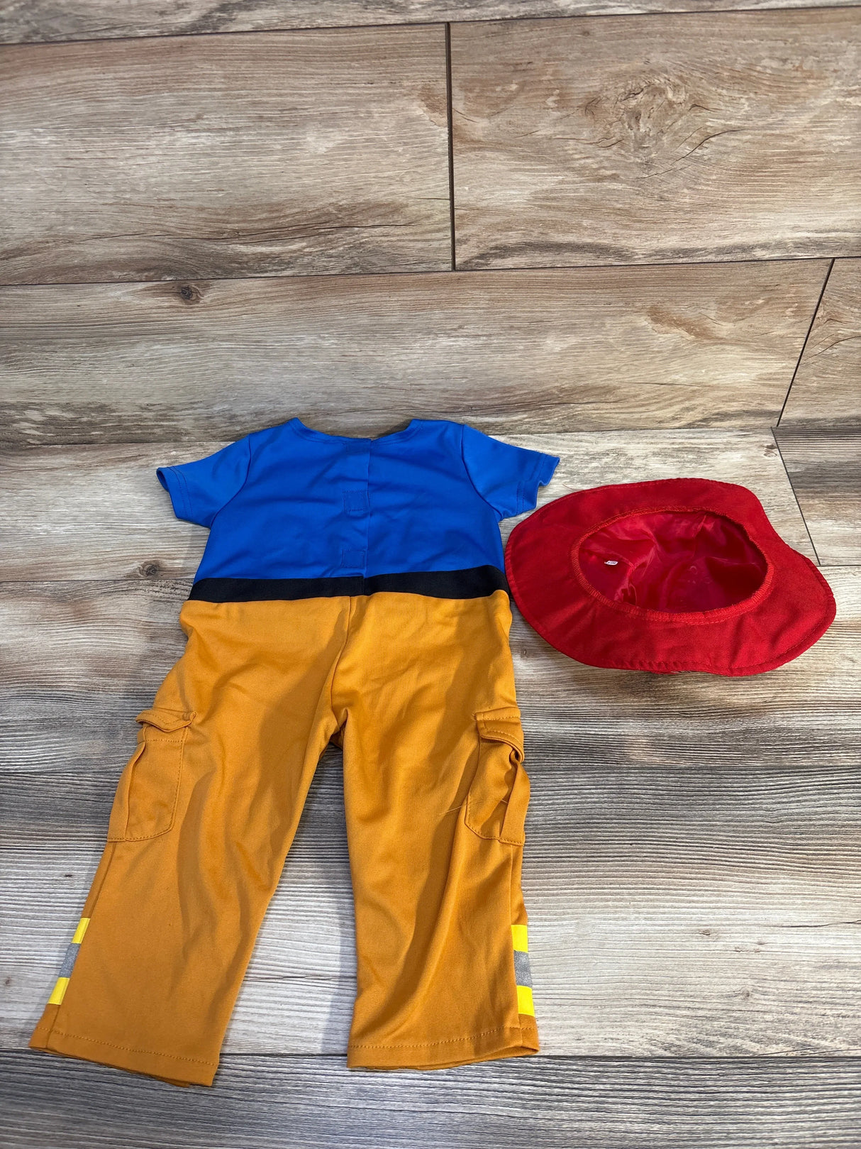 Blue and yellow toddler outfit with red hat, perfect for kids' playtime or costumes.