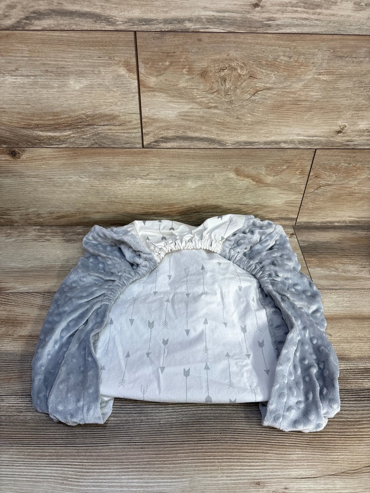 Top view of Cloud Island Arrow Changing Pad Cover showcasing gray plush fabric, white arrow pattern, and elastic edges
