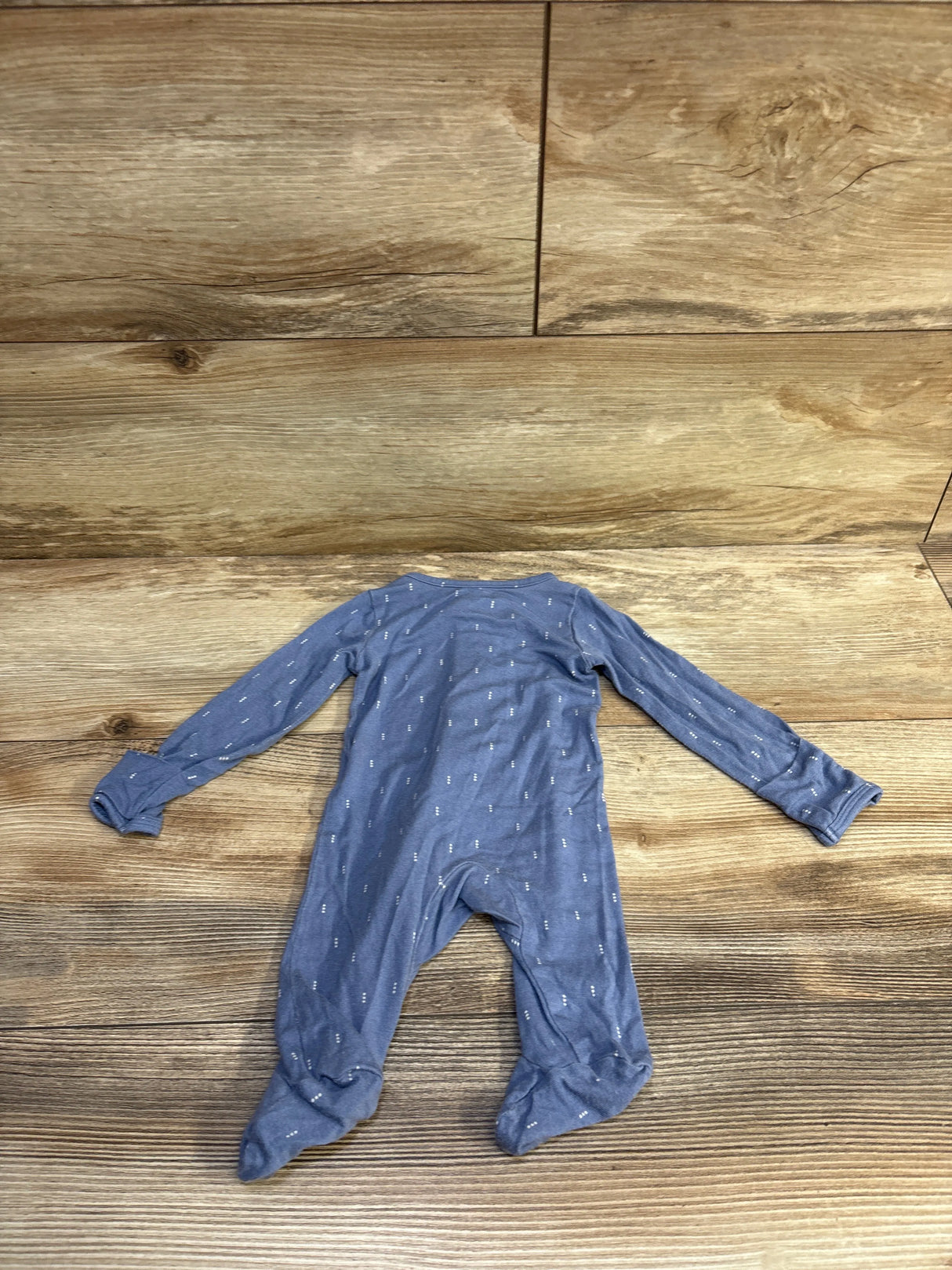 Back view of Just One You PurelySoft newborn blue footed sleeper with small white dashes, long sleeves, laid flat on wood background