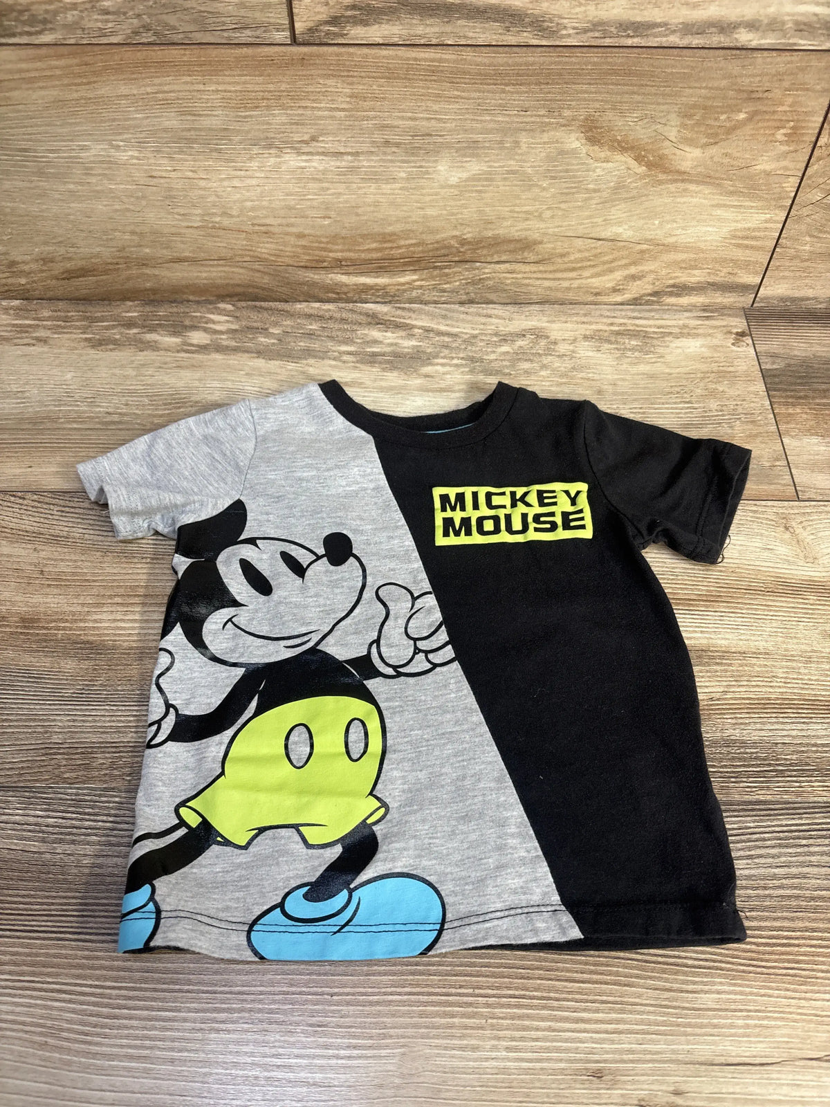 Front view of Disney Mickey and Friends shirt in size 2T showcasing split gray and black design with Mickey Mouse graphic