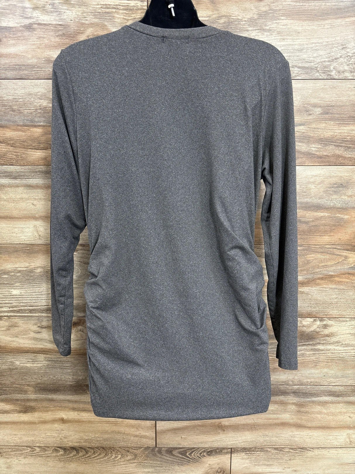 Back view of Ekouaer grey maternity long sleeve V neck shirt showcasing side ruching on a mannequin against wood background