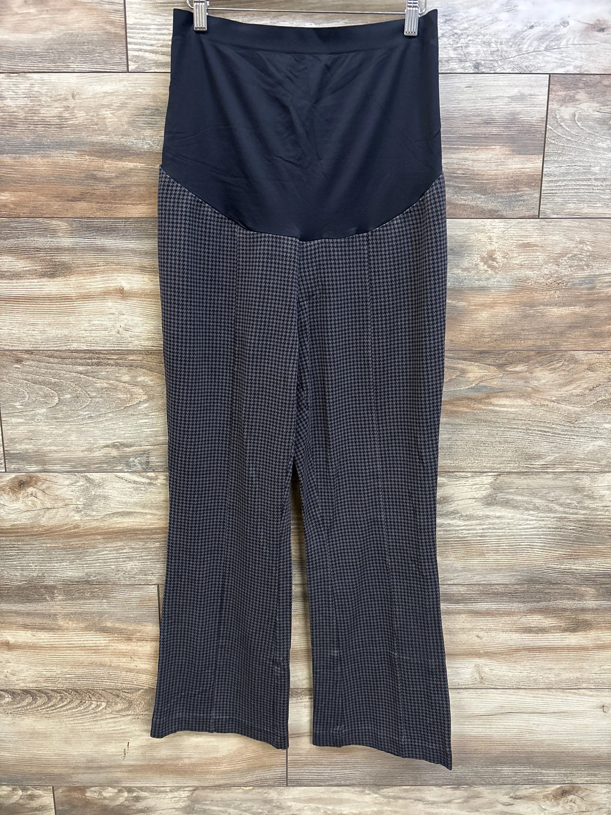 Front view of Sonoma maternity full panel patterned pants showing a black panel and gray patterned wide legs on wood-look flooring