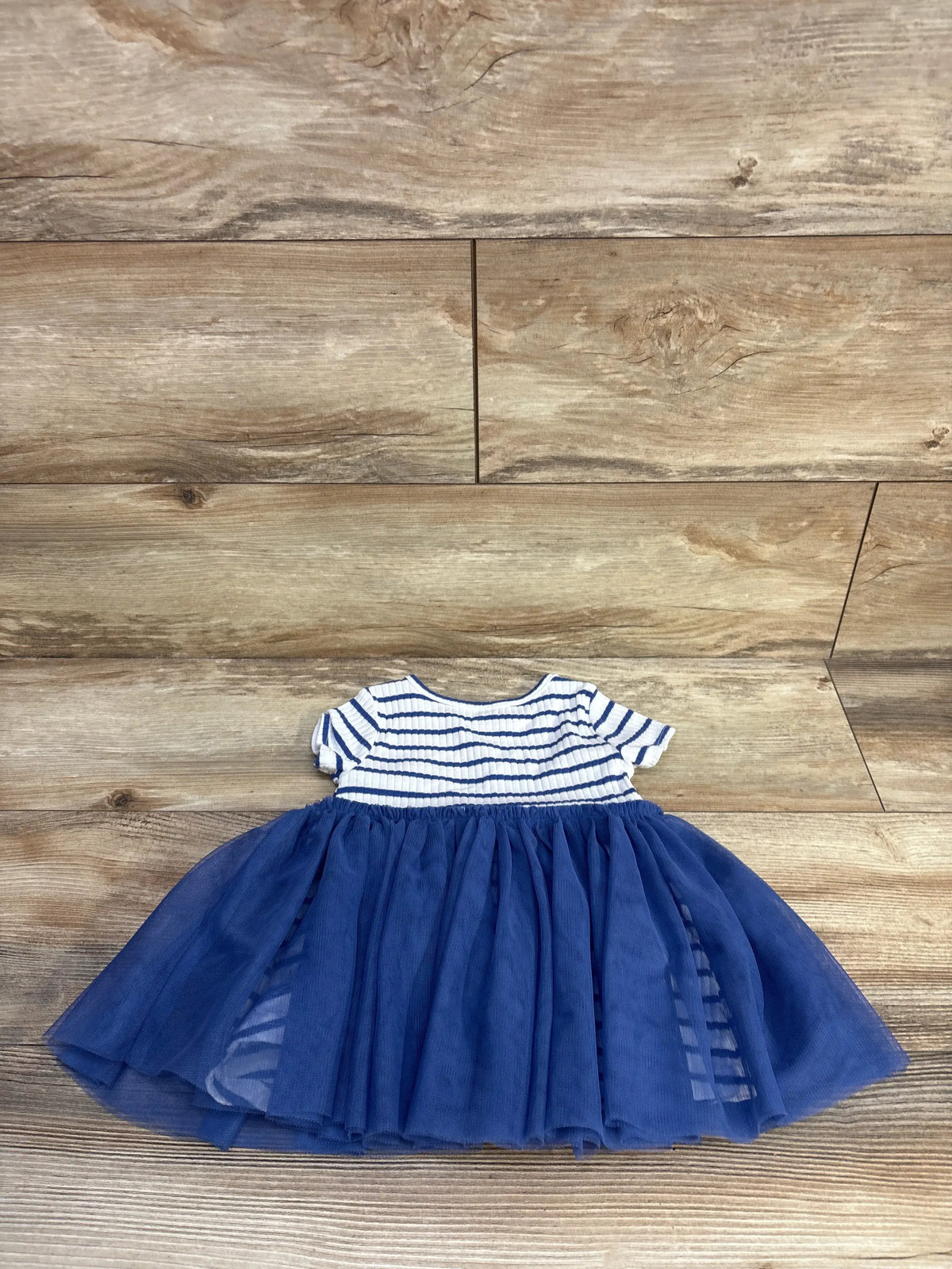 Wonder Nation striped ribbed white top and navy blue tulle skirt baby dress on wood background