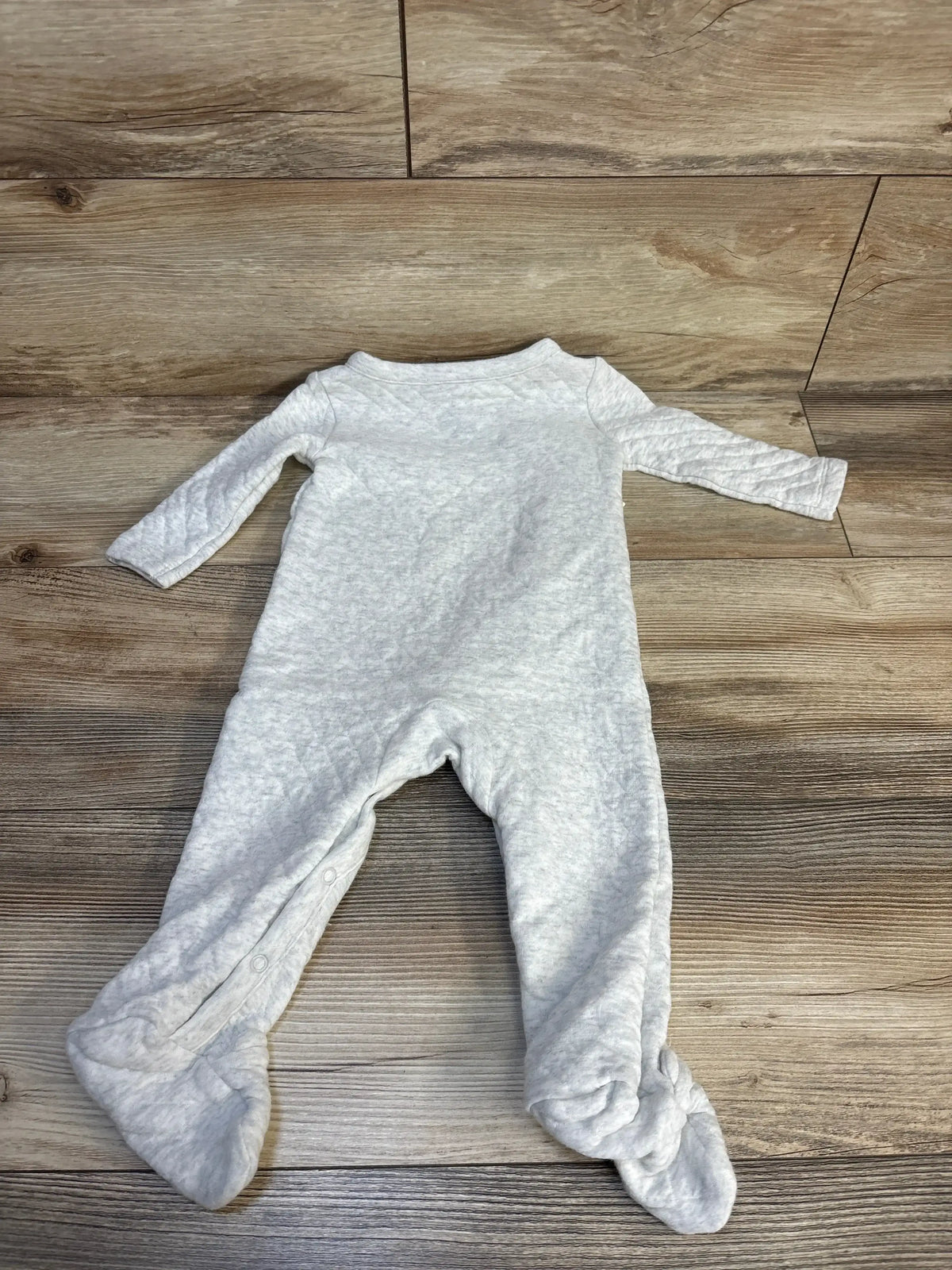 Light gray footed baby sleeper with long sleeves on wood floor, gently used kids clothing