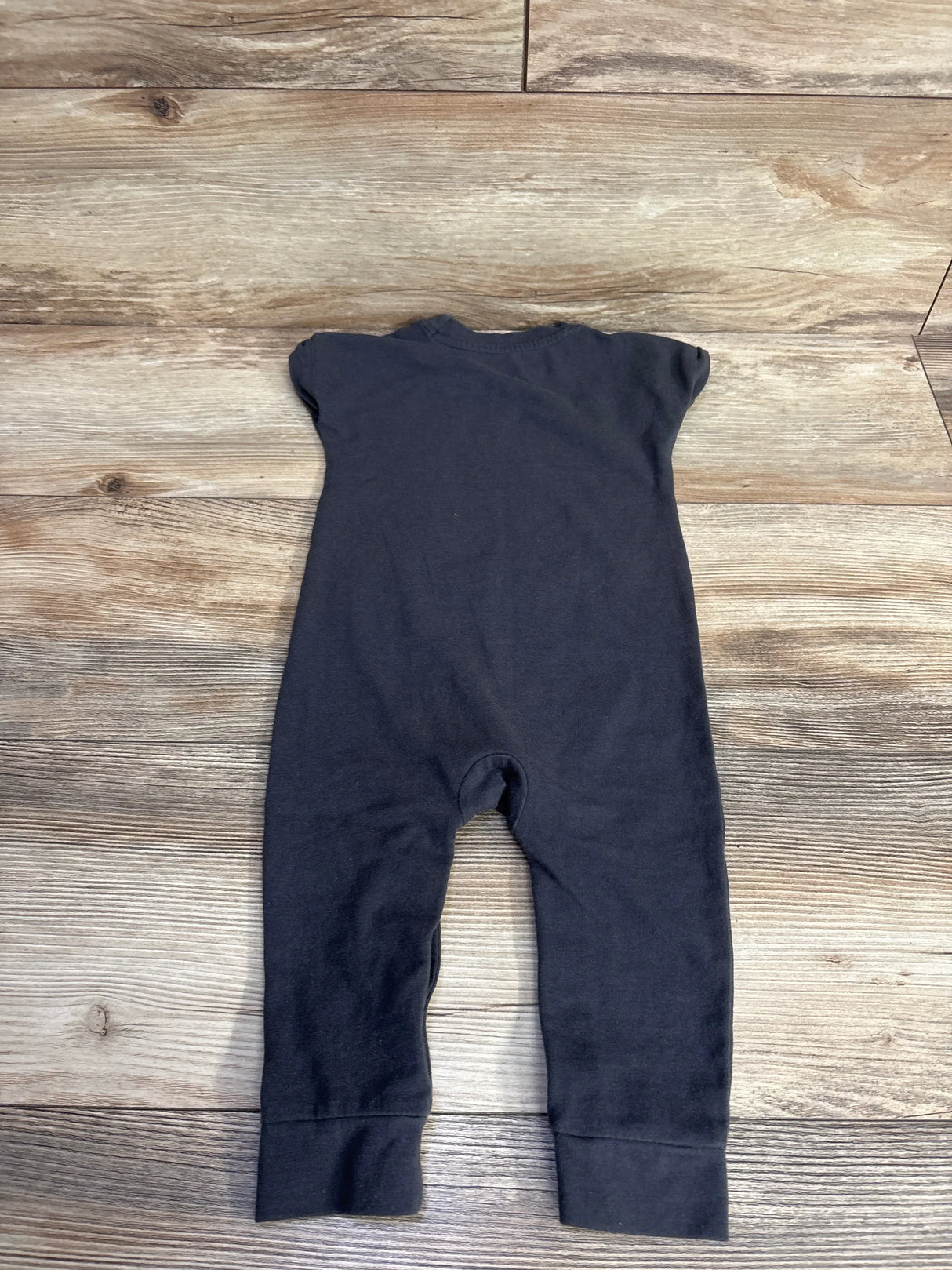 Back view flat lay of Cat and Jack My First Rodeo romper in grey size 6-9m showcasing short sleeves on wood plank floor