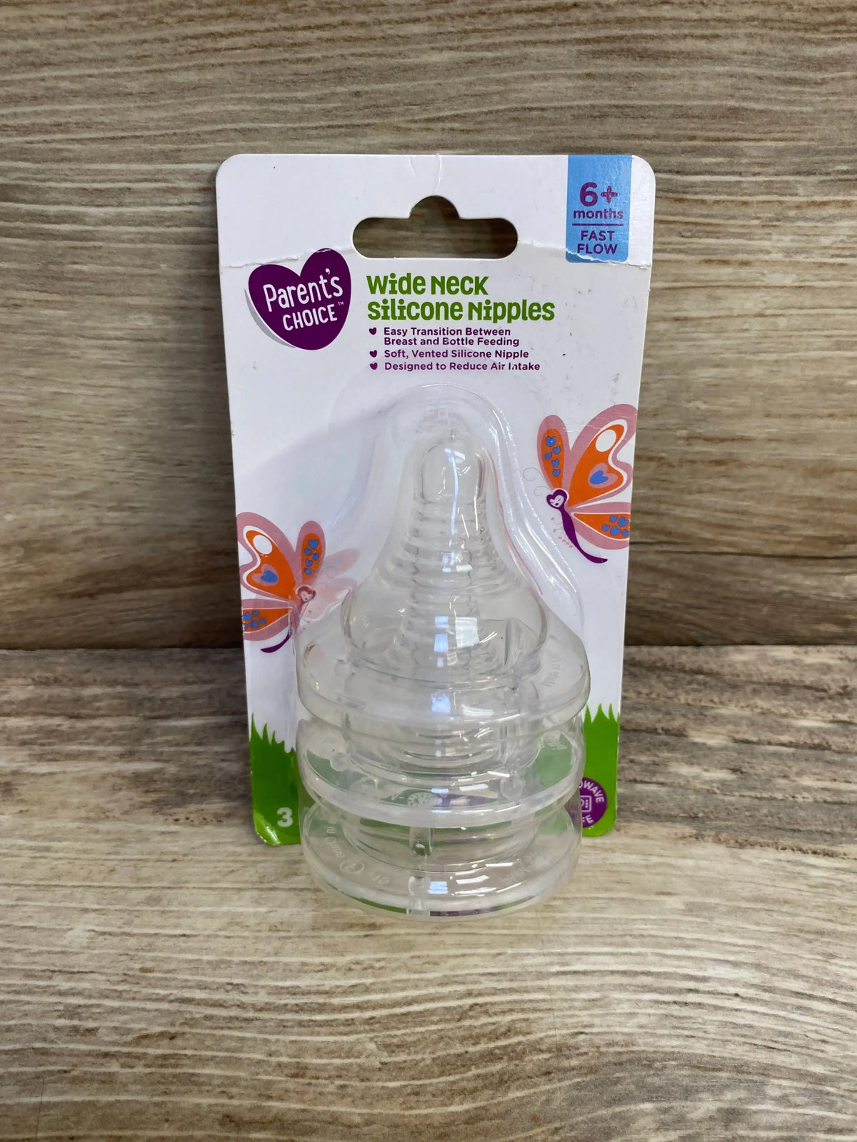 Front of Parent’s Choice 3-pack wide-neck silicone nipples showcasing clear silicone teats with white packaging on wood background