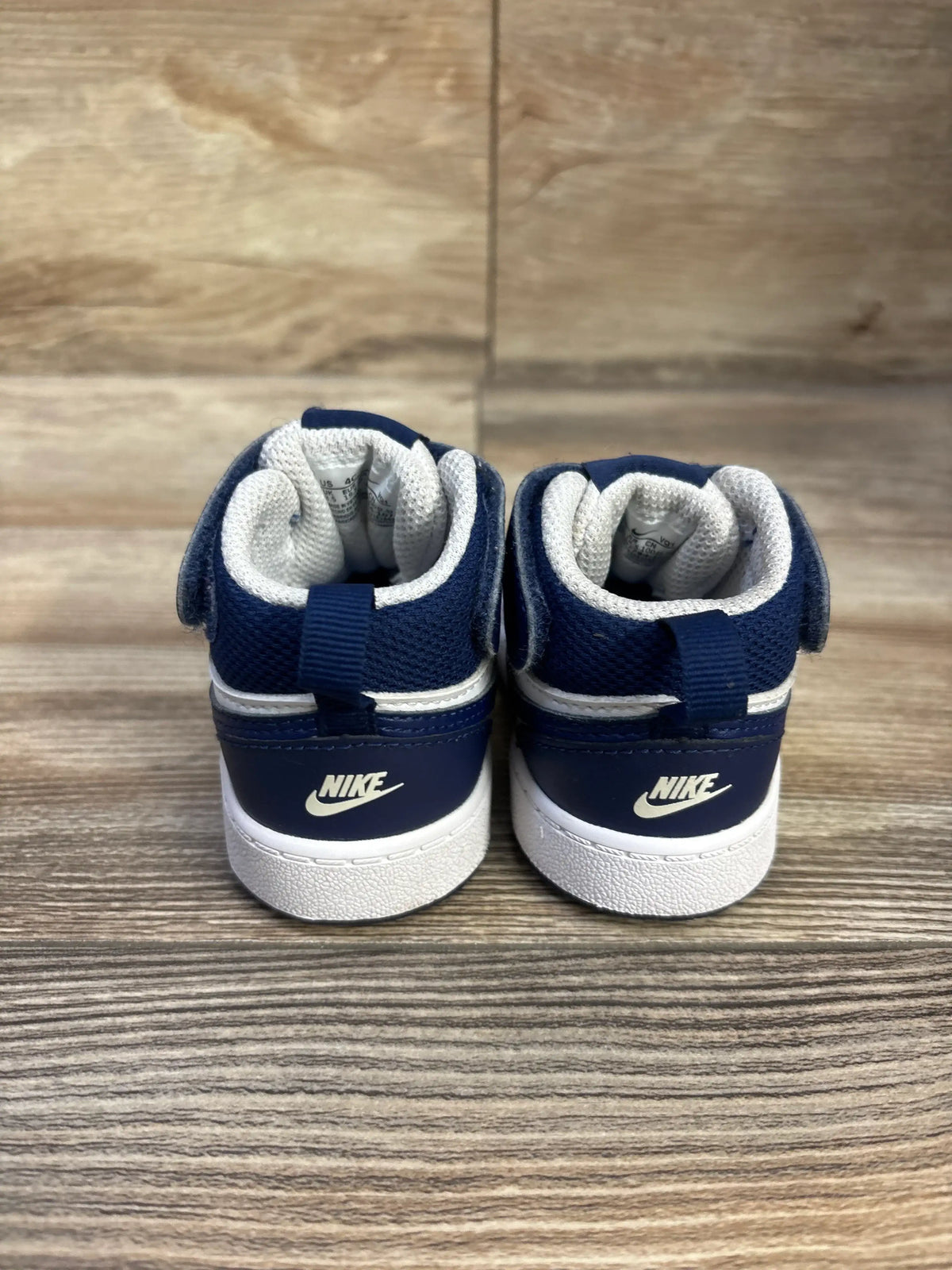 Rear view of Nike Court Borough Mid 2 TD sneakers in white and signal blue, with padded collars and white soles