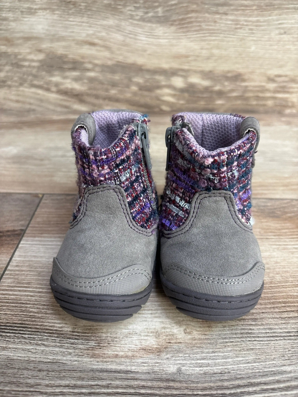 Gray suede toddler boots with purple knit fabric, zipper sides, on wooden floor